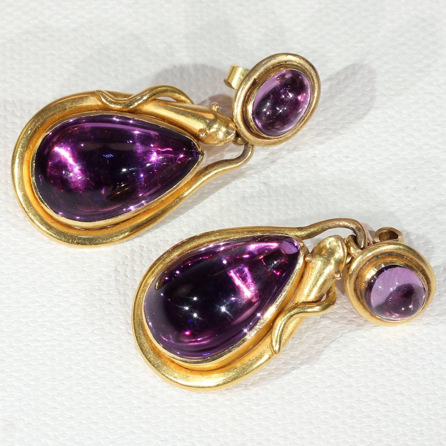 This antique amethyst and gold snake necklace and earrings set was handcrafted before 1854 in 14 karat gold. Overall, this striking set weighs 71.3 grams, boasts 7 perfect purple amethysts, and is surrounded in gold and serpent symbolism.  The