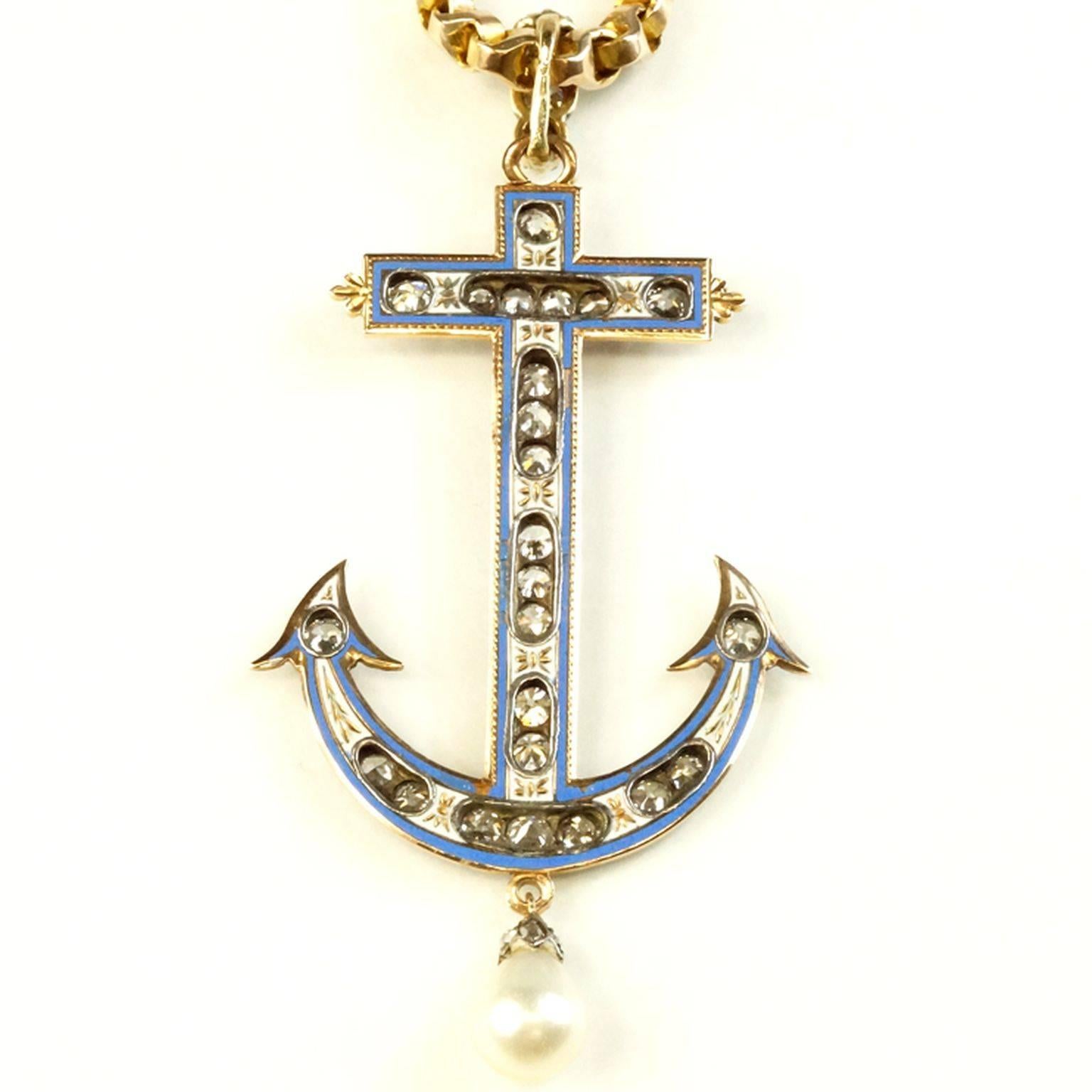 Amazing C. 1860 white gold and yellow gold with blue enamel diamond
anchor pendant. Approximately 2.00 ct. Old European cut diamonds with beautiful hand engraving front and back. Natural pearl with diamond top drops from the bottom.
Measures