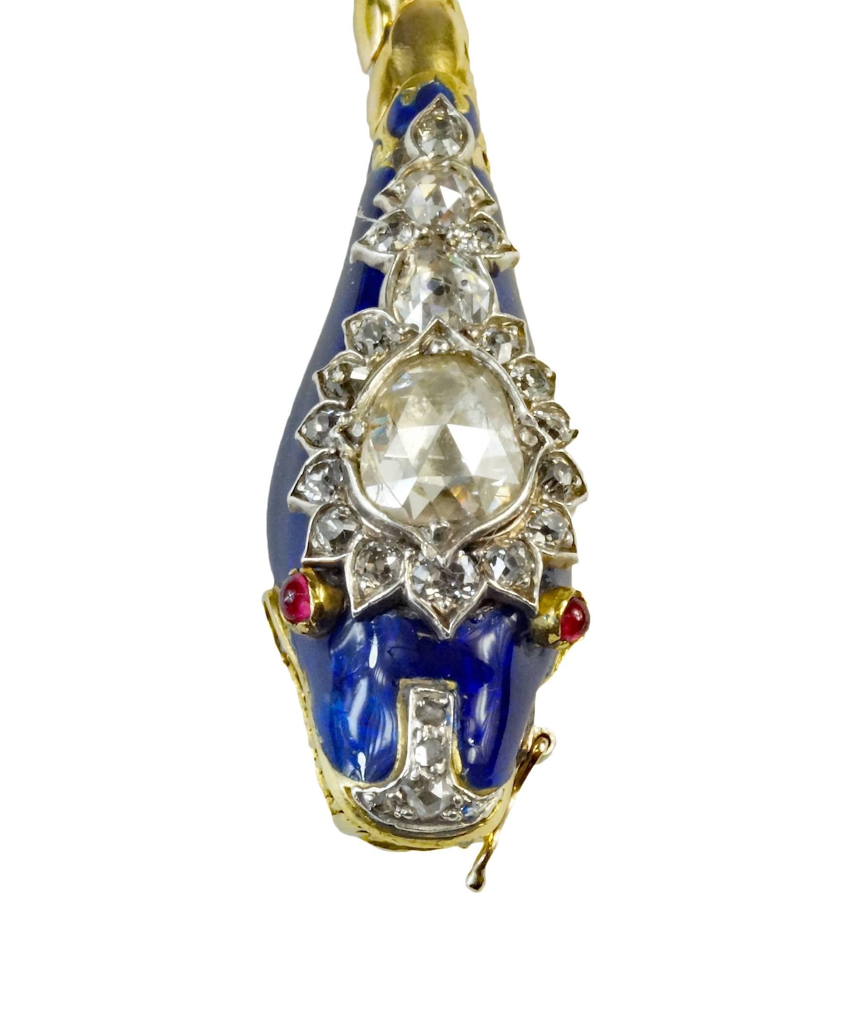 As versatile as it is beautiful, this 18k yellow gold Victorian era serpent can be worn as a necklace or bracelet. The blue enamel head is set with small mine-cut diamonds. It is centered with a pear-shaped rose-cut diamond weighing approximately
