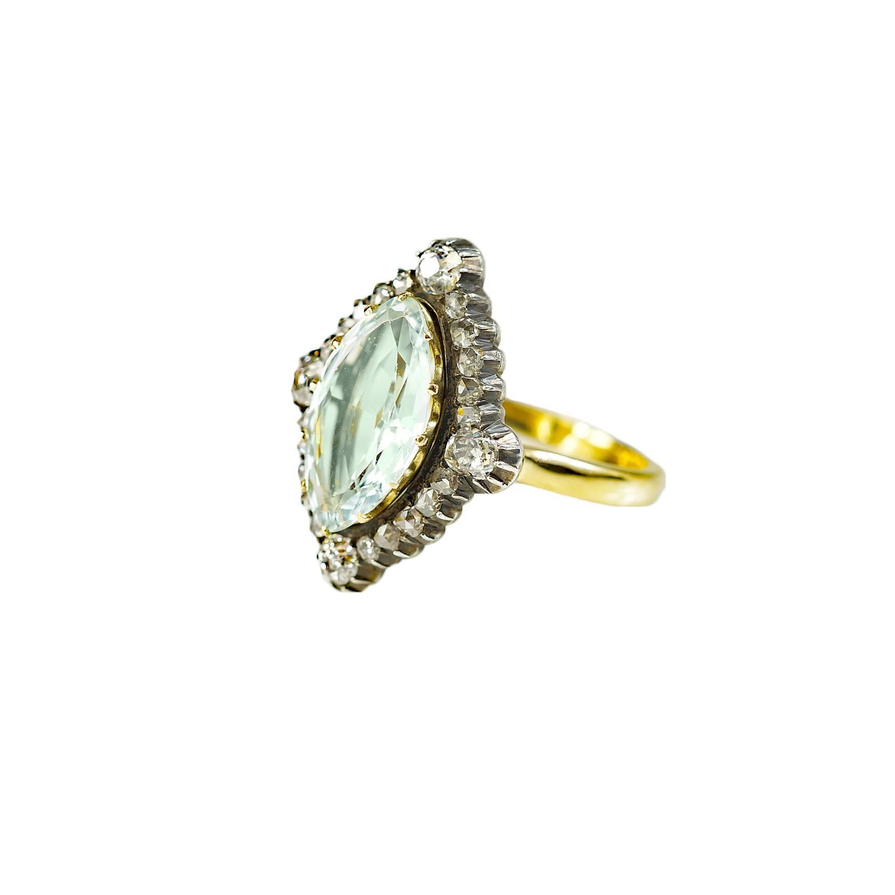 Soft beautiful bright marquise cut aquamarine center stone surrounded by rose cut diamonds and old mine cut diamonds.  Later ring mounting added in 18ct yellow gold.  