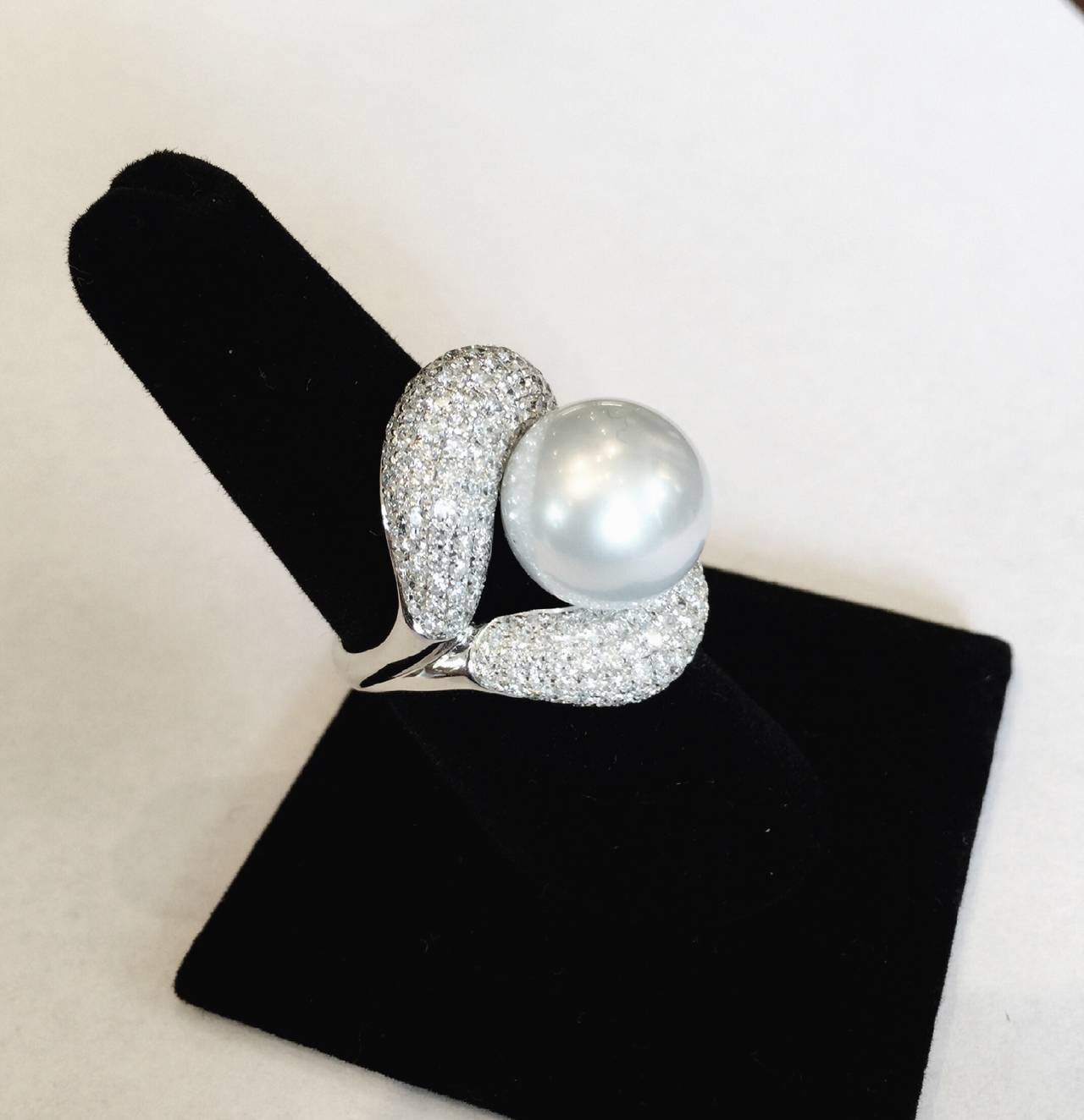 Fabulous cultured, silvery white, 13.50mm round south sea pearl with perfect skins and wonderful lustre.  There are 224 diamonds that make up the 3.00cts of pavé diamonds in the ring. The ring is in 18k white gold.
