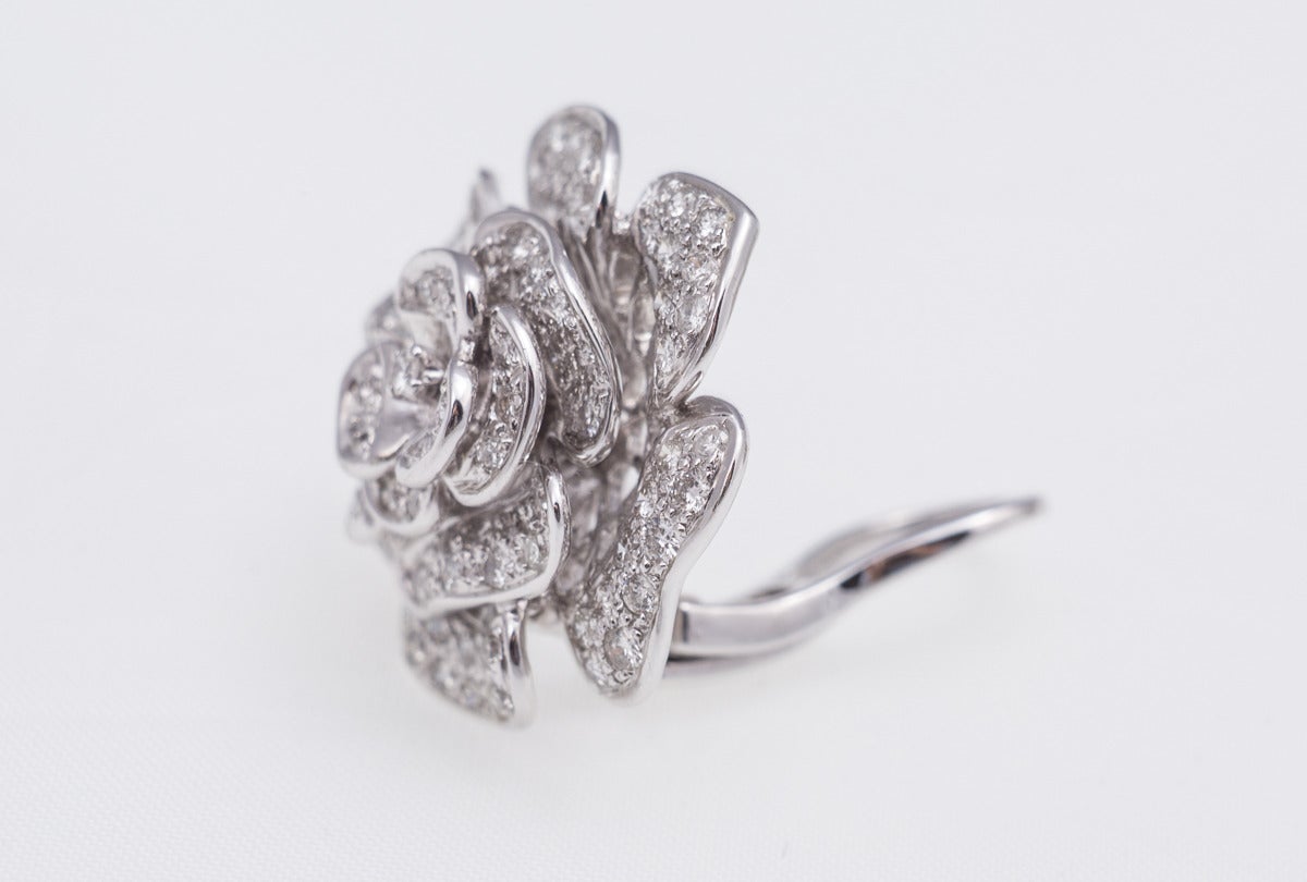 One pair of diamond flower earrings that sit right on the ear with post and clip backings, the earrings can be worn as clips. There are 2.00cts of G-H color, VS-SI1 clarity diamonds. The earrings are in 18k white gold and are very beautiful!