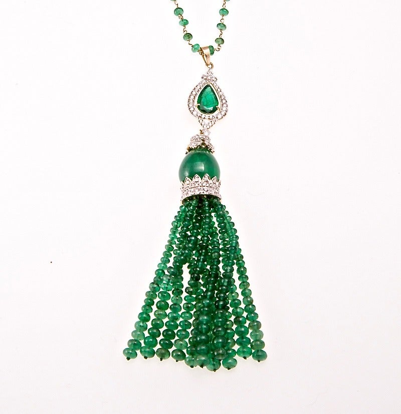 Magnificent natural emerald and diamond tassel necklace. The pear shape emerald at the top weighs 1.57cts and the large cabochon emerald weighs 19.30cts. The emerald beads weigh 58.54cts. The diamonds are G-H color and VS clarity and weigh 1.39cts