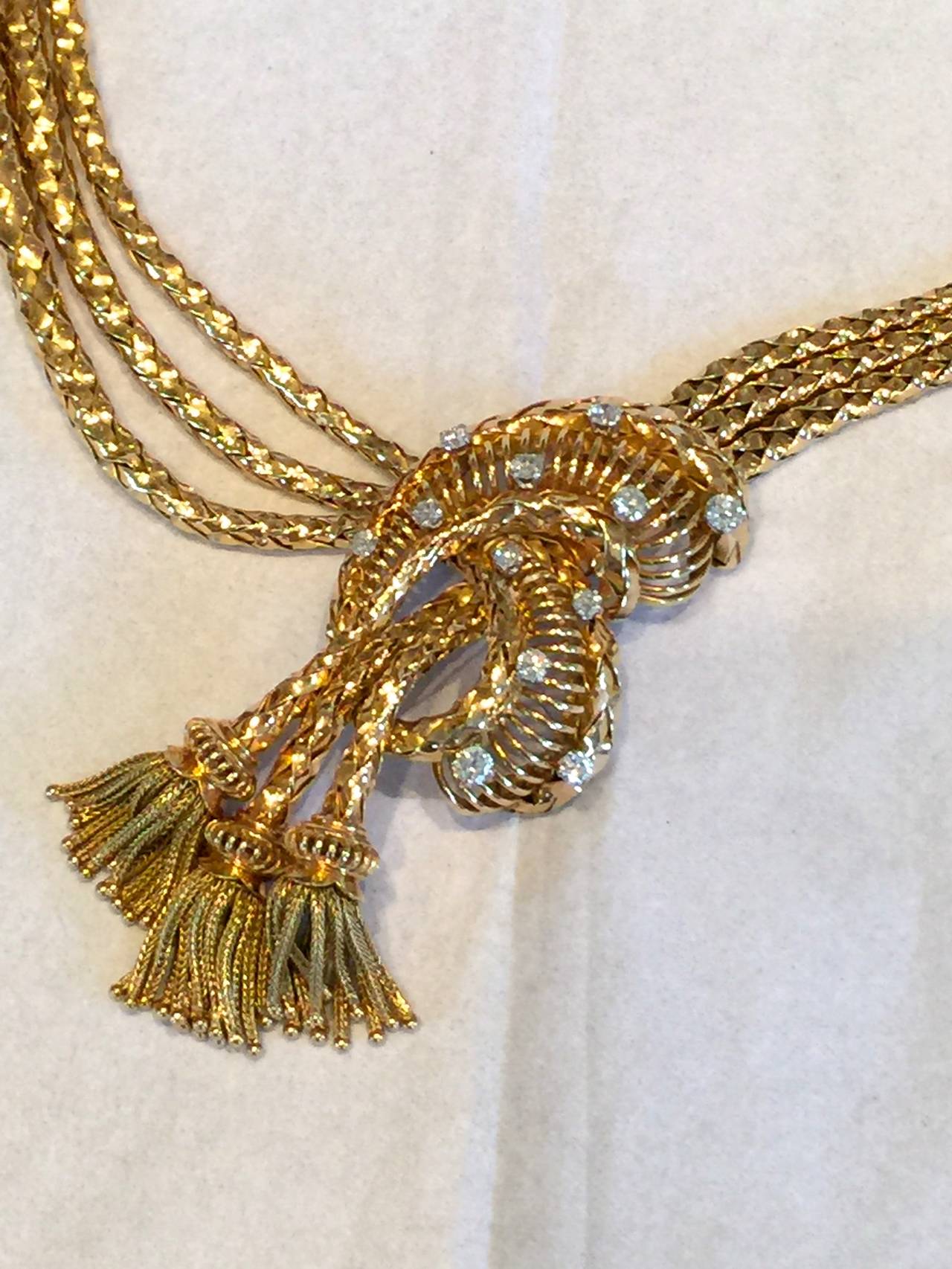 Fabulous retro necklace circa.1945. The necklace is 18k yellow gold and has approximately 1.50cts in diamonds on top of a wonderful open gold knot with three decorative tassels. The necklace is 15
