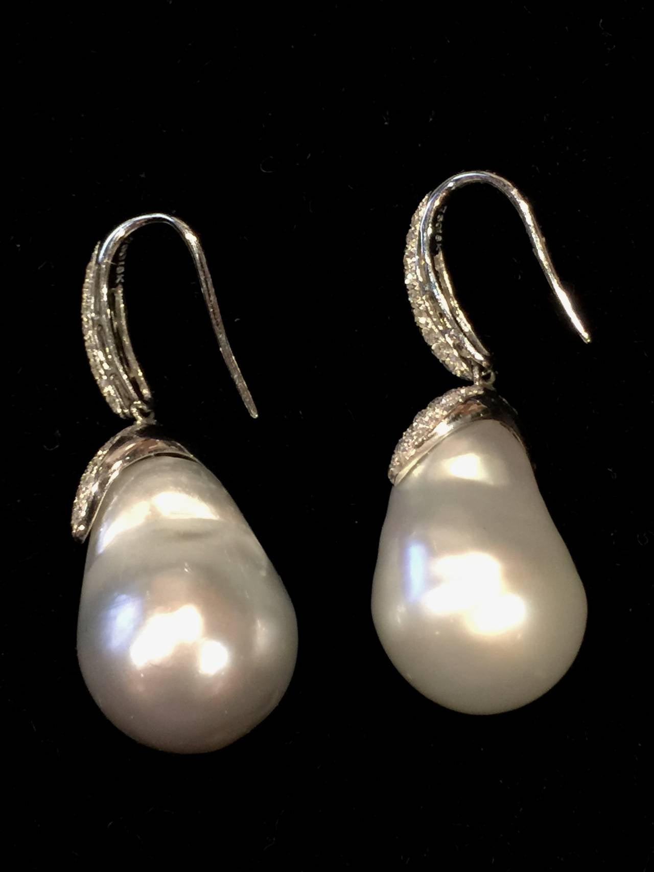 Cultured South Sea Baroque Pearl and Diamond earrings.  The South Sea Pearls measure 20.30mm x 14.80mm and 20.00 x 14.70mm, have excellent luster and silvery white color. Each earring has micro-pavè weighing approx. .75cts, totaling 1.50cts for