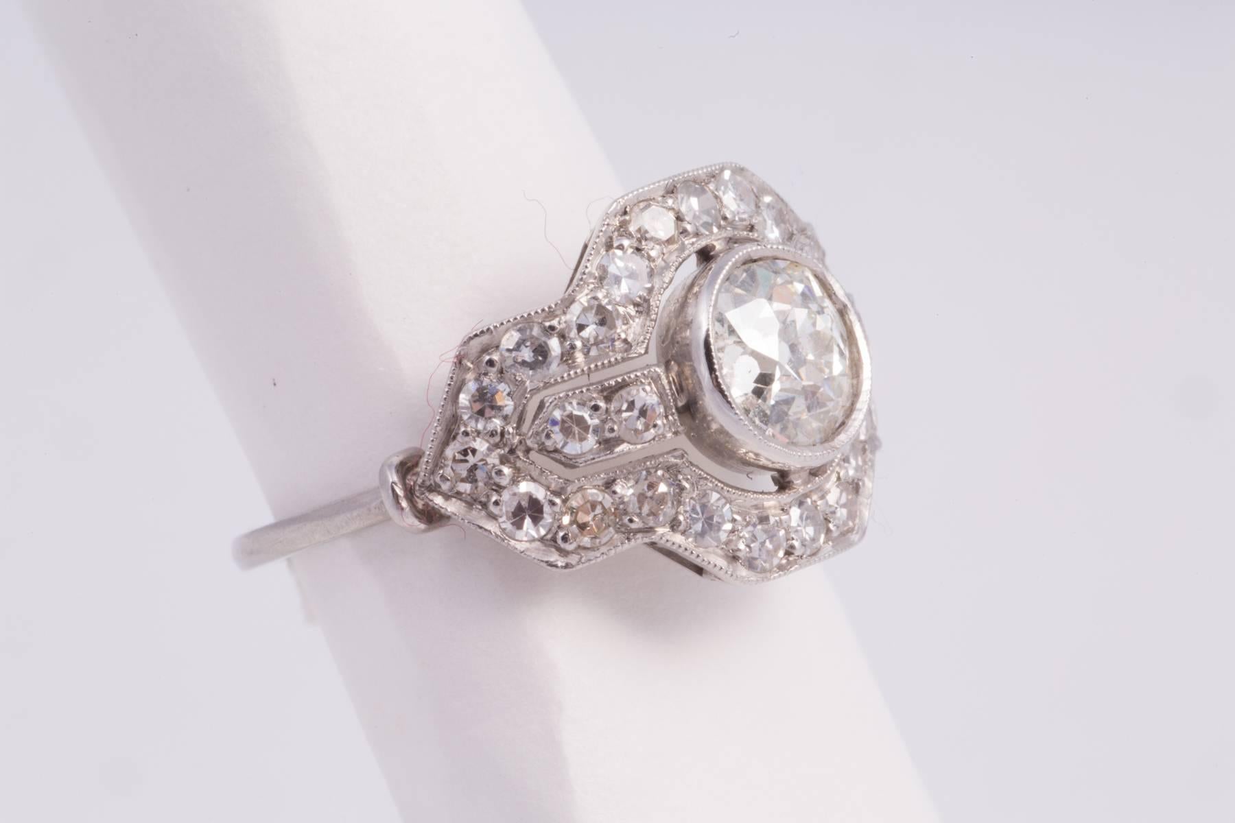 Platinum and diamond ring, The center diamond is european cut and weighs approx. 1.00ct having I-J color and SI clarity. There are 30 single cut diamonds weighing approx. 1.00cts with H-I color and VS clarity, circa. 1930