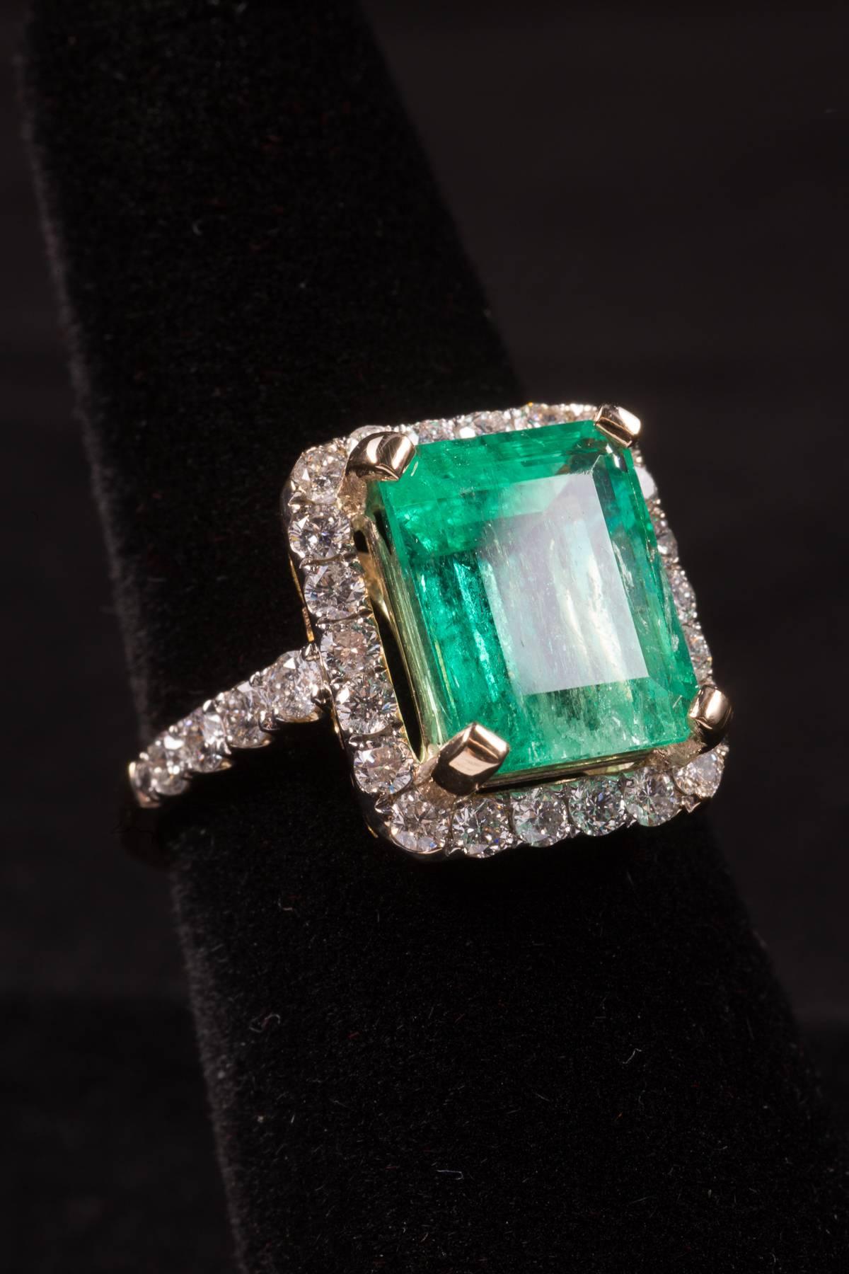 Art Deco 5.12 Columbian Emerald Ring with 1 carat of Full Cut Round Diamonds.
Size 7