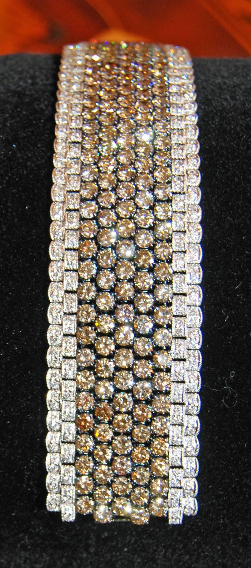 18K White Gold bracelet featuring Brown, Yellow and White Diamonds Throughout with Pave Accents and an Invisible Clasp.

24.50tw Fancy Brown Round Brilliant Diamonds  SI1-2
5.64ctw White Round Brilliant Diamonds Near Colorless  
.10 Round