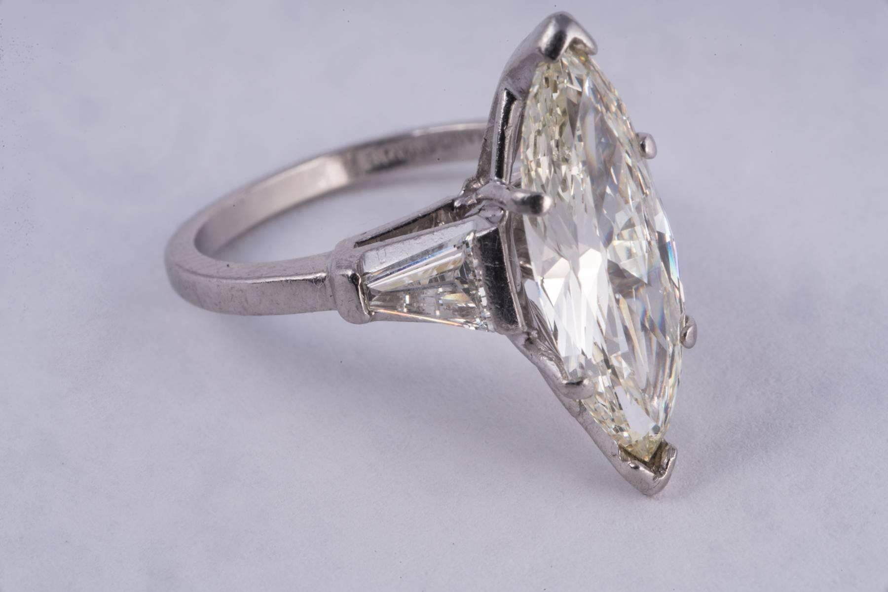 Amazingly large and great looking 2.36ct Marquise diamond ring. This ring is huge and the diamond  is gorgeous! The diamond had J color and VS clarity. It is set in platinum with a large taper baguette on each side.