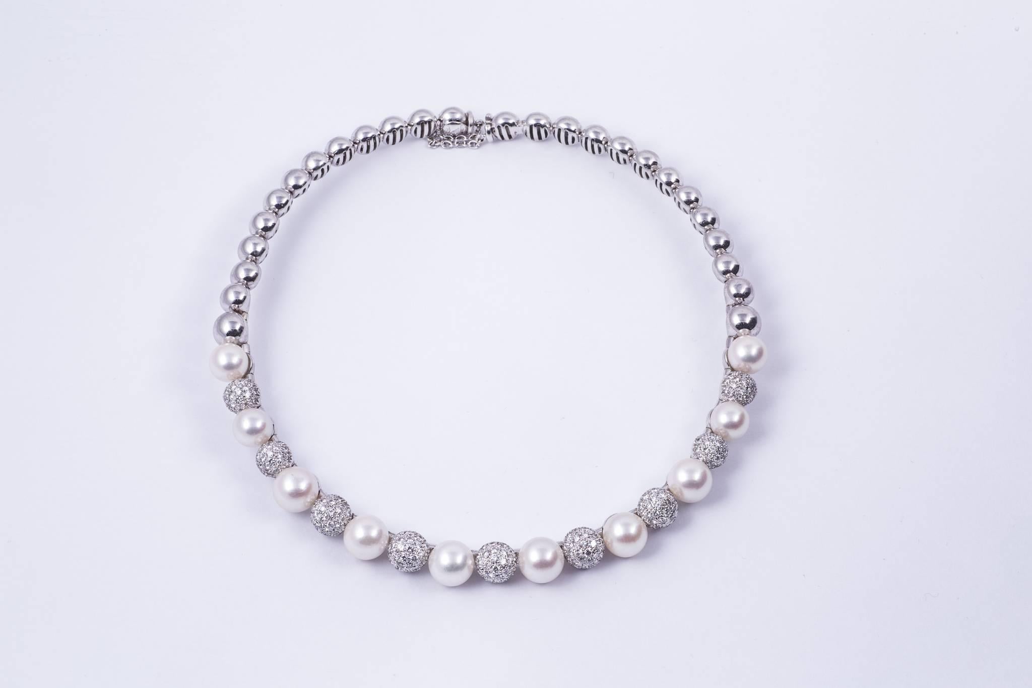Elegant cultured akoya pearl and diamond necklace. The center pearl measures 9.20mm graduating to 8.2mm. There are 10 pearls in total. There are 9 pavé diamond balls in-between the pearls. The total weight of the diamond is approx. 8.00cts and the