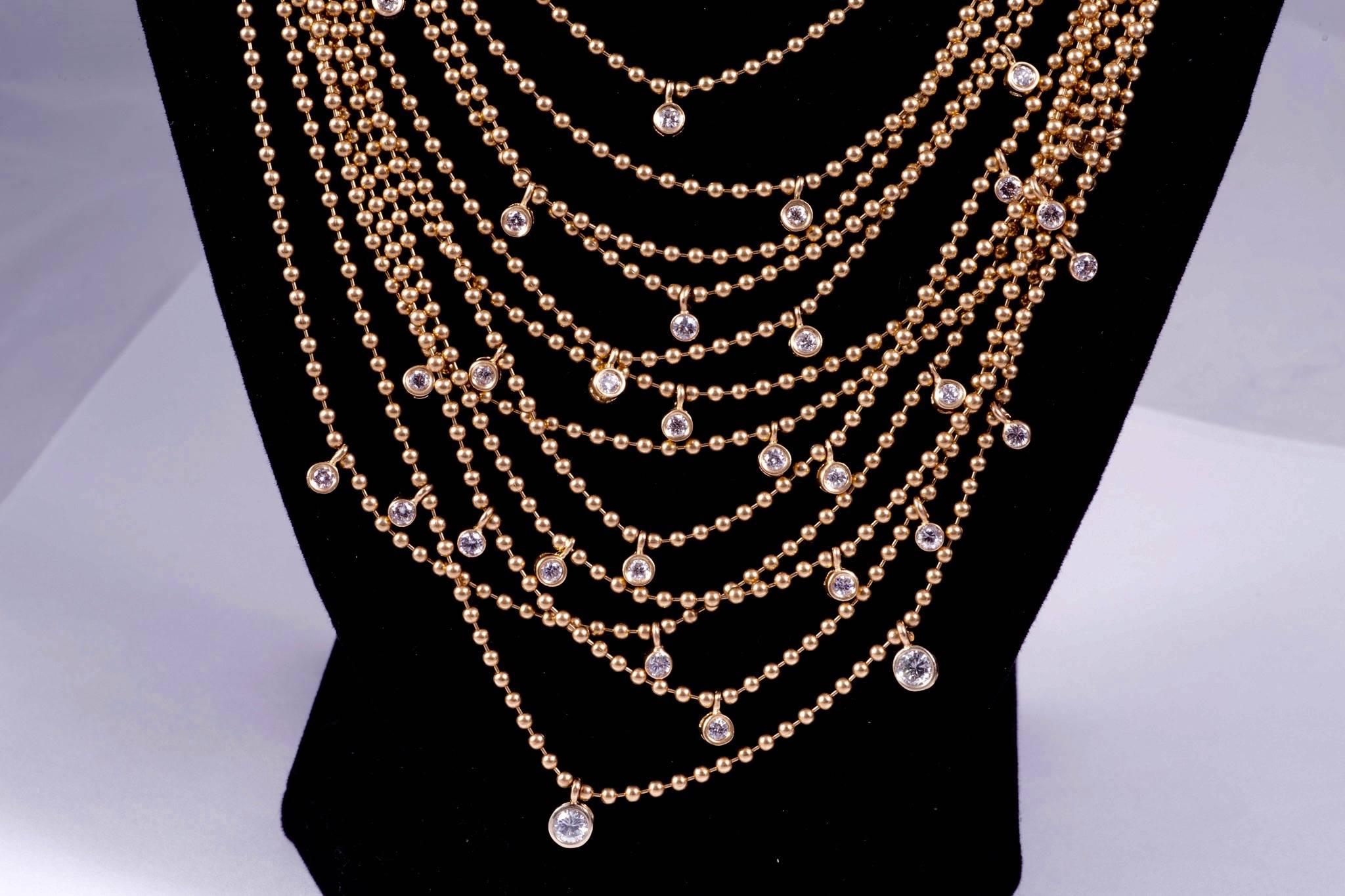 Gorgeous gold necklace of draping gold and diamonds. The necklace has 12 chains, the graduate from 15 1/2