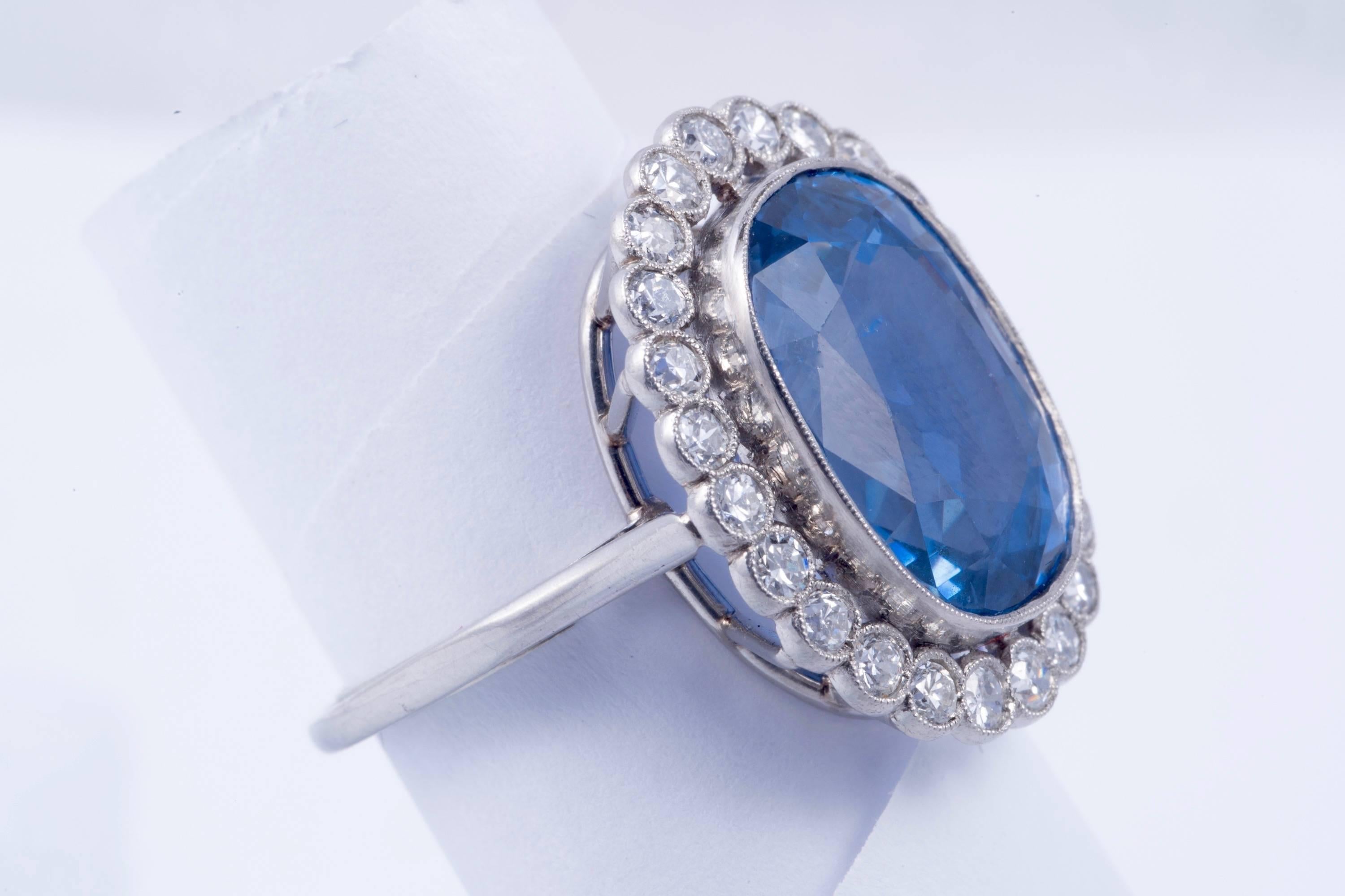 Magnificent Natural Blue Sapphire and Diamond Ring. The center sapphire is certified by the  American Gemological Laboratories (AGL) as Natura colorl and and of Ceylon origin. The sapphire weighs 12.41cts. There are 24 european cut diamonds weighing