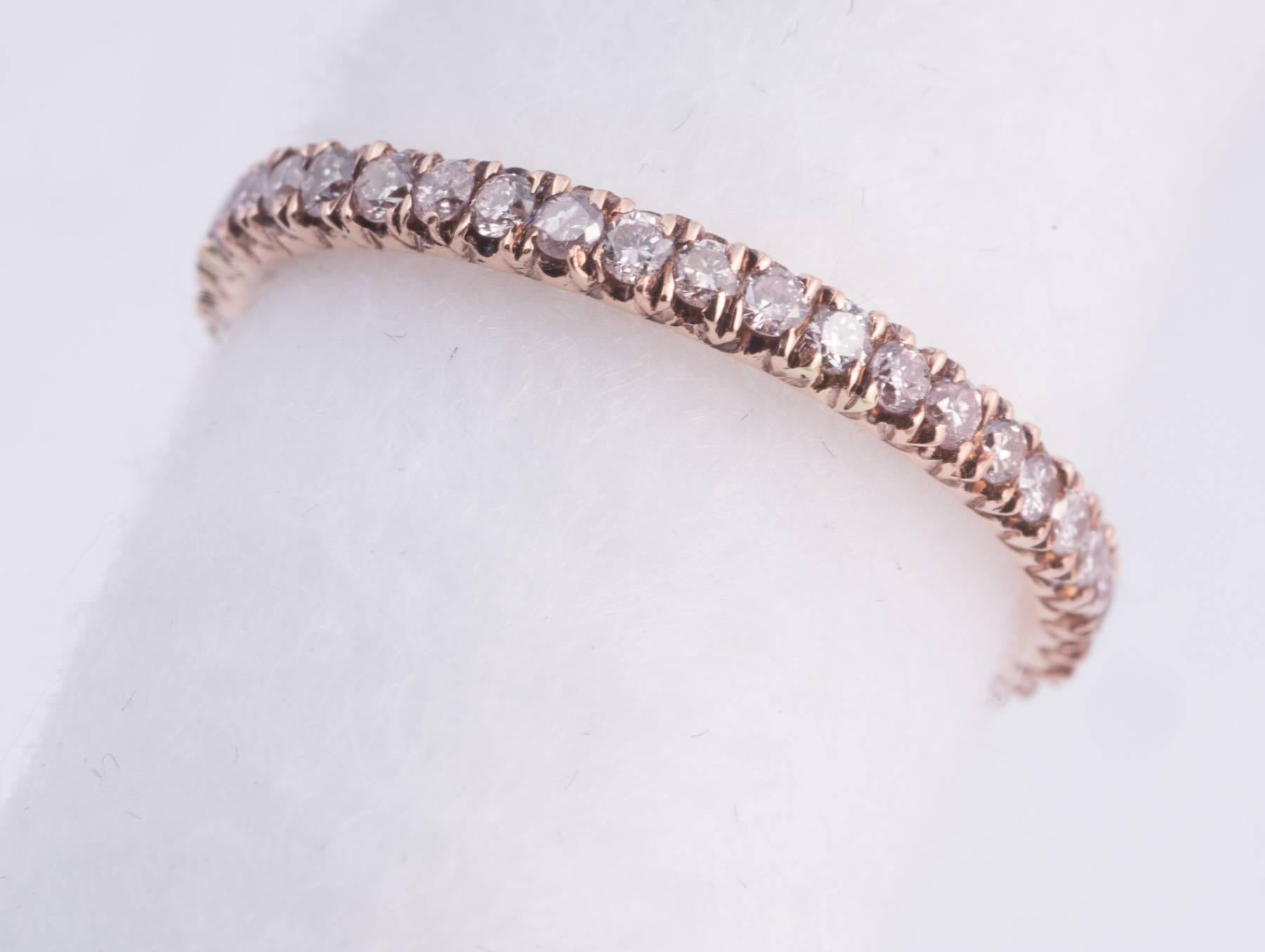 Fabulous pink diamond band with natural color pink diamonds and VS clarity. The band is set in 18k rose gold. The diamonds weigh .65cts. Ring size 7.5. The band is 2.3mm wide.