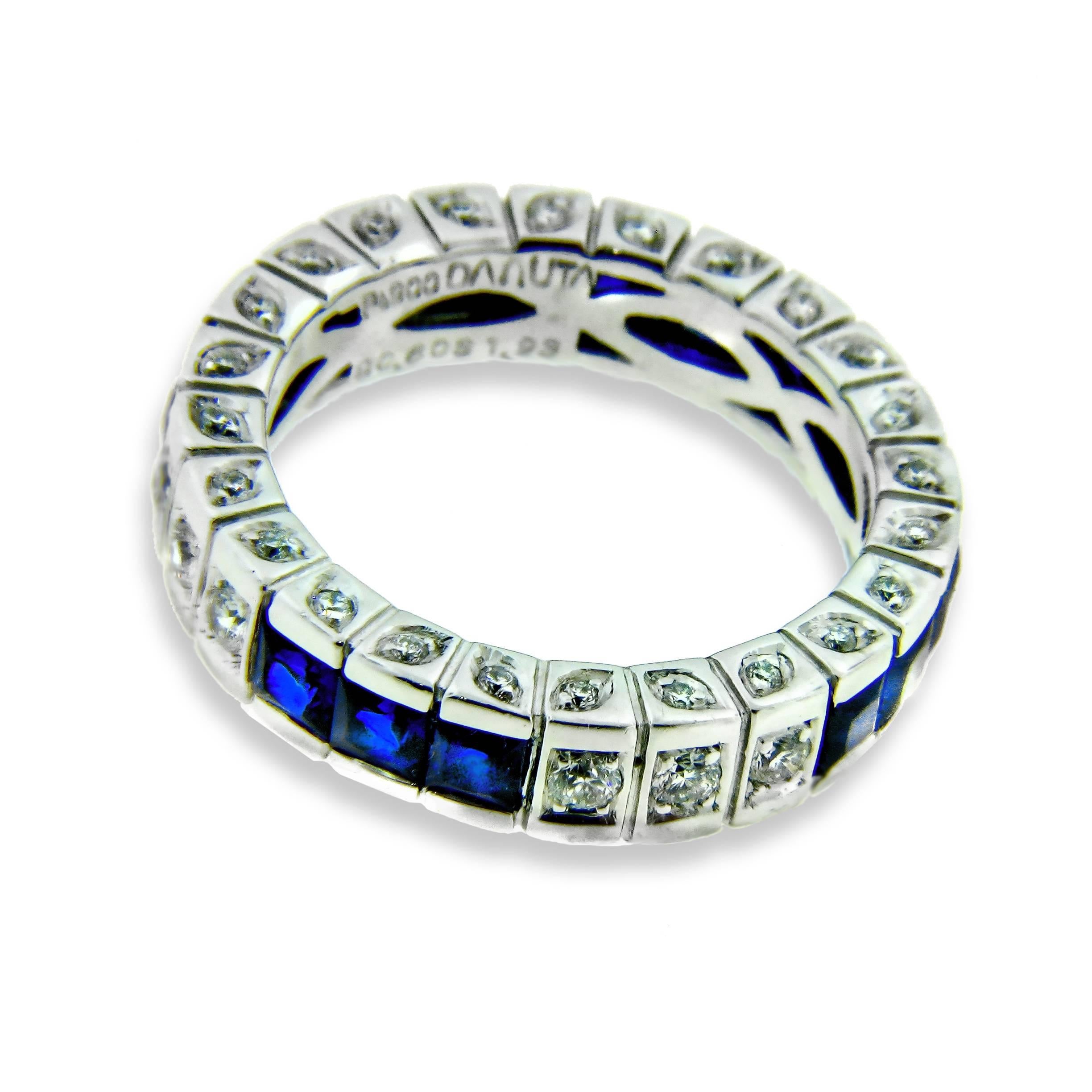 This stunning platinum eternity band features four sets of three princess-cut deep blue sapphires (1.93ct) and four sets of three round-cut pave diamonds in an alternating pattern completely around the band's surface. 

Note the attention to detail