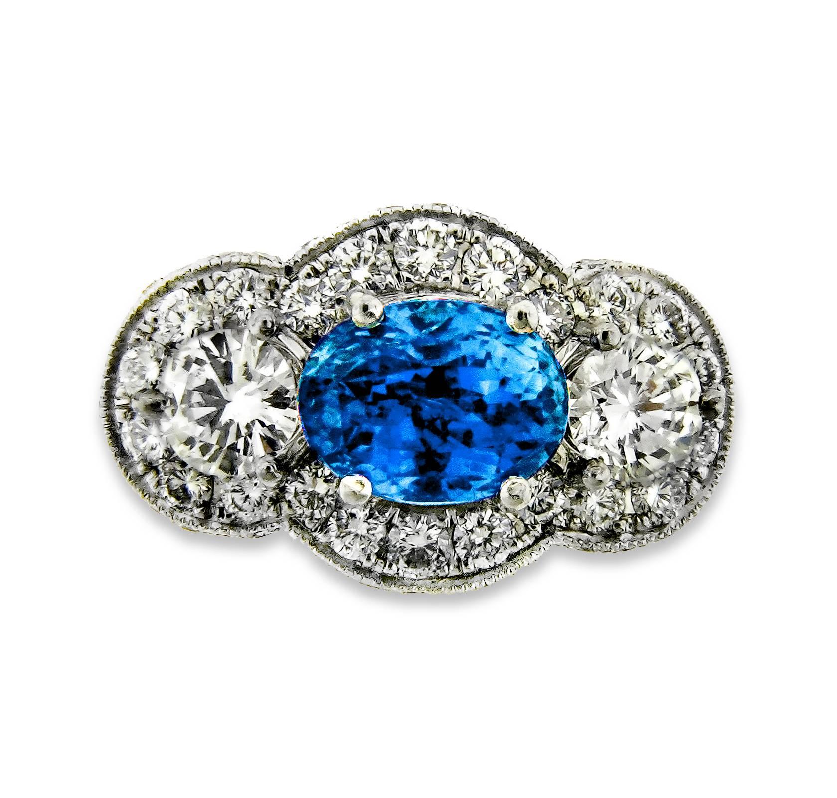 This dazzling platinum and striking non-heated Ceylon Sapphire (2.11 carat) cocktail/engagement ring designed by Danuta, will be sure to inspire compliments and appreciation. 

The radiant pair of 30 pt F/Vs1 side diamonds and shining 1ct total