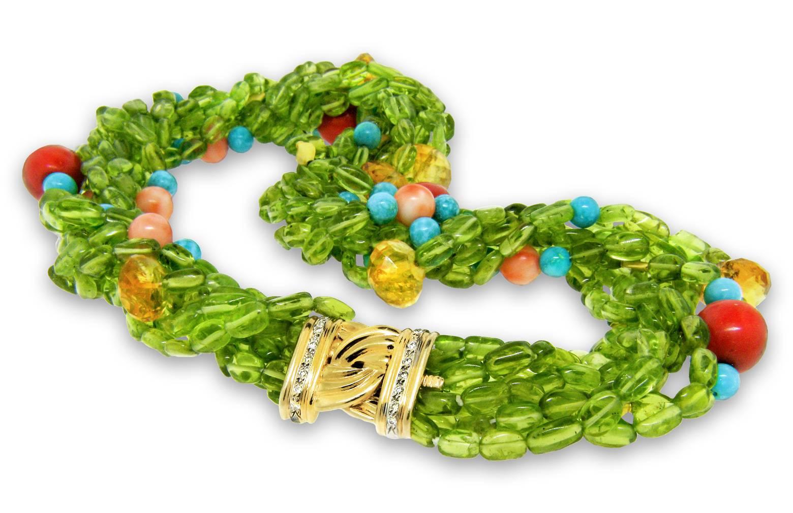 This elegant 8-strand Peridot necklace by Danuta, features a variety of stones consisting of antique coral beads, faceted Citrine, Sleeping Beauty Turquoise, and Peridot beads interspersed with 18k gold separator beads.

The decorative clasp is 18k