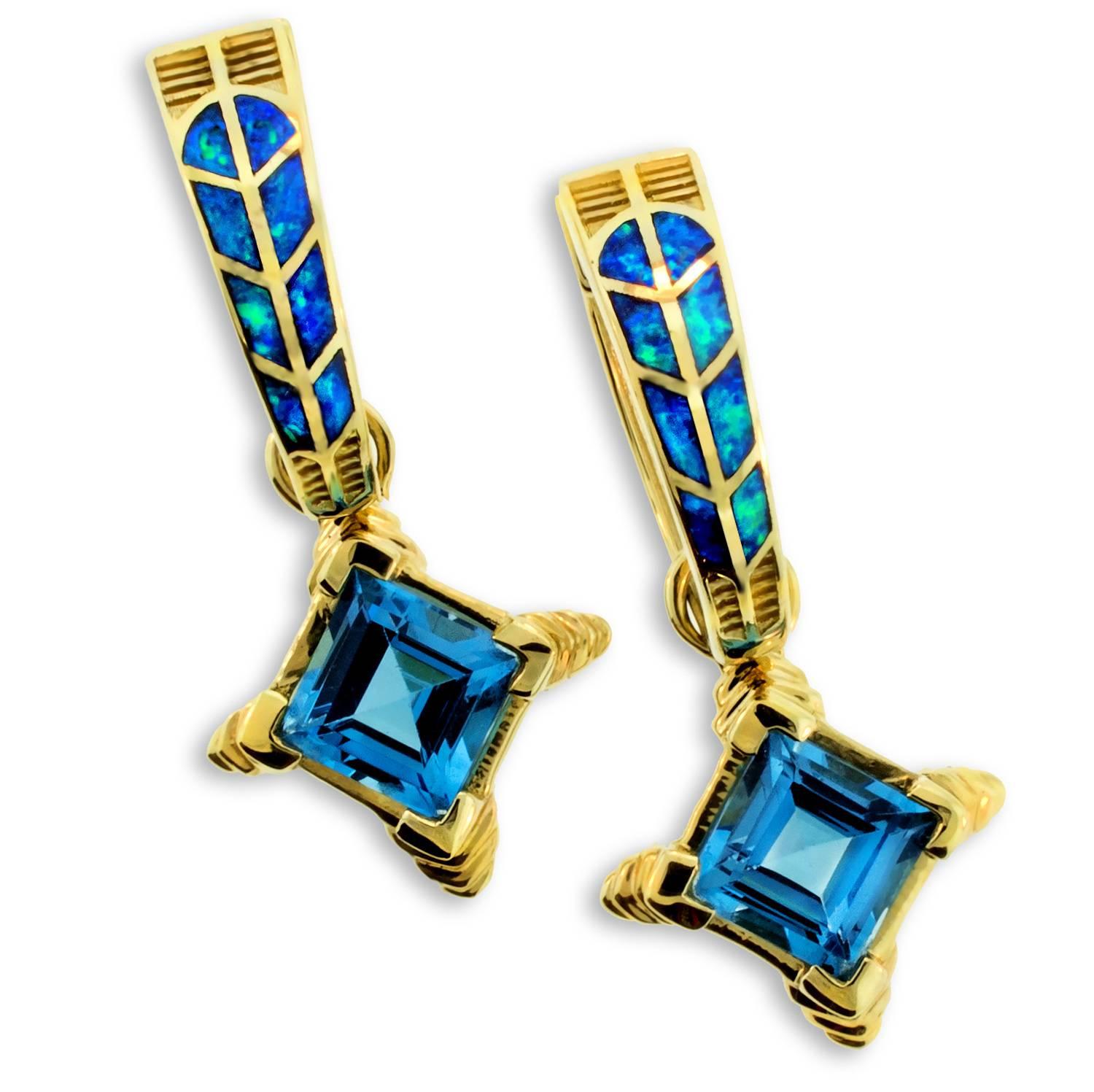 Spectacular inlaid precious Australian Opal earrings which feature a Hawk Feather motif. 14 karat gold with detachable Blue Topaz pendants, these earrings are two in one and offer maximum versatility. Created by international jewelry design award