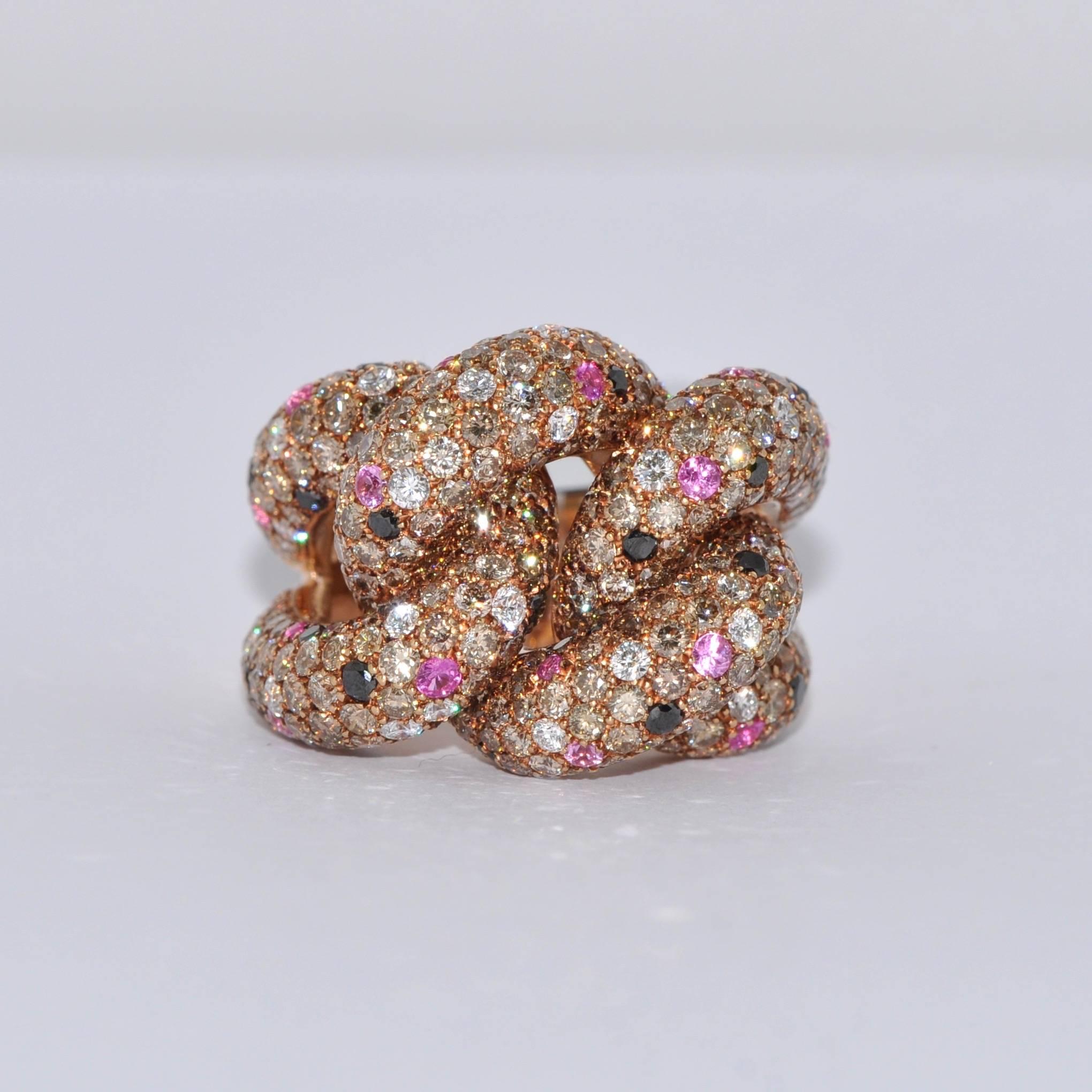 Black and White Diamonds with Pink Sapphires Yellow Gold Interlaced Ring.
Black Diamonds  0.52 Carat
White Diamonds 0.70 Carat
Brown Diamonds 6.30 Carat
Pink Sapphires 0.62 Carat
Yellow Gold 18 Carat
French Size 53/54
US Size 6 1/4 6 3/4