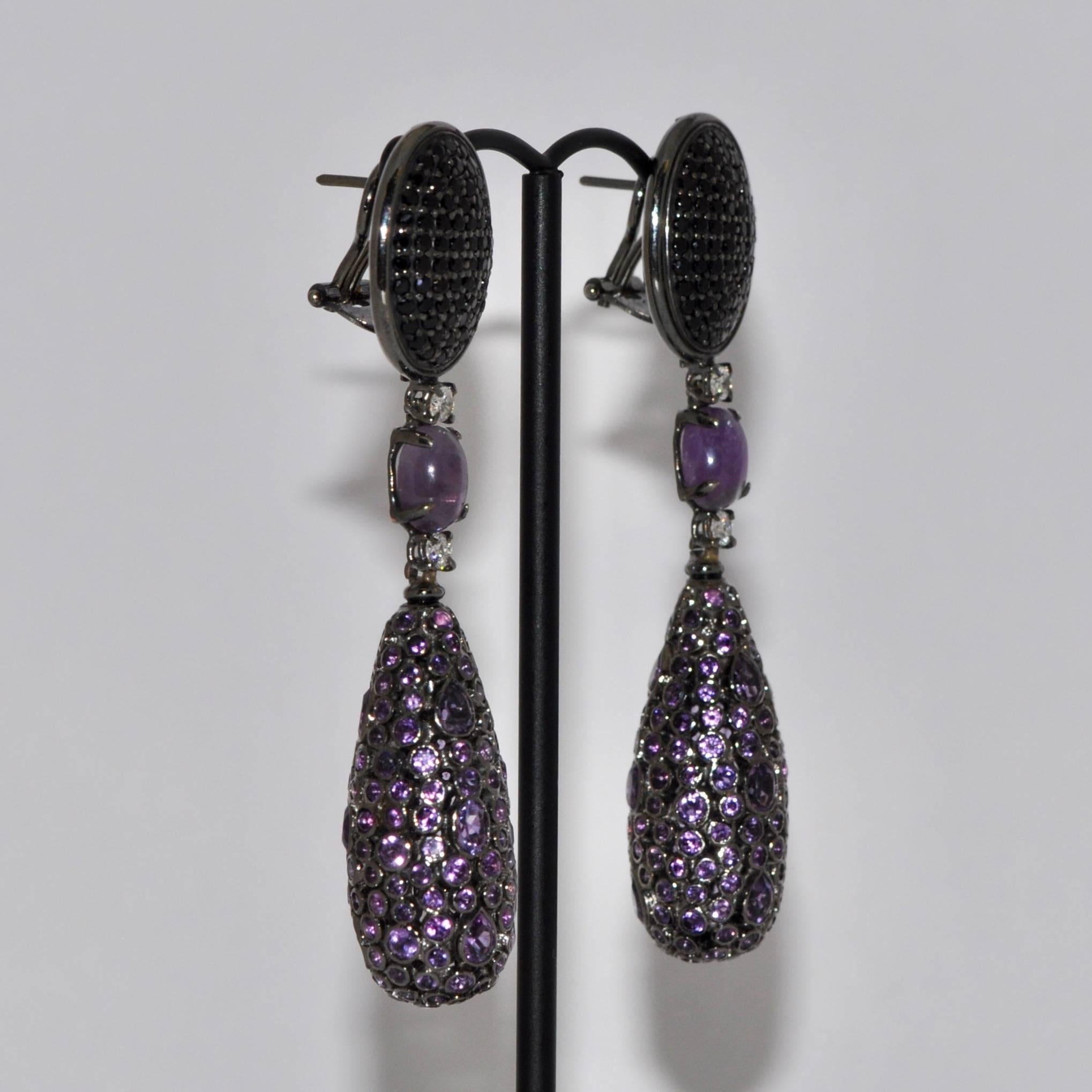 Discover this Amethyst, Spinel and White Diamonds Silver and Black Gold Chandelier Earrings.
Amethyst
Black Spinel 
White Diamonds 0.28 Carat
Silver 
Black Gold 18 Carat