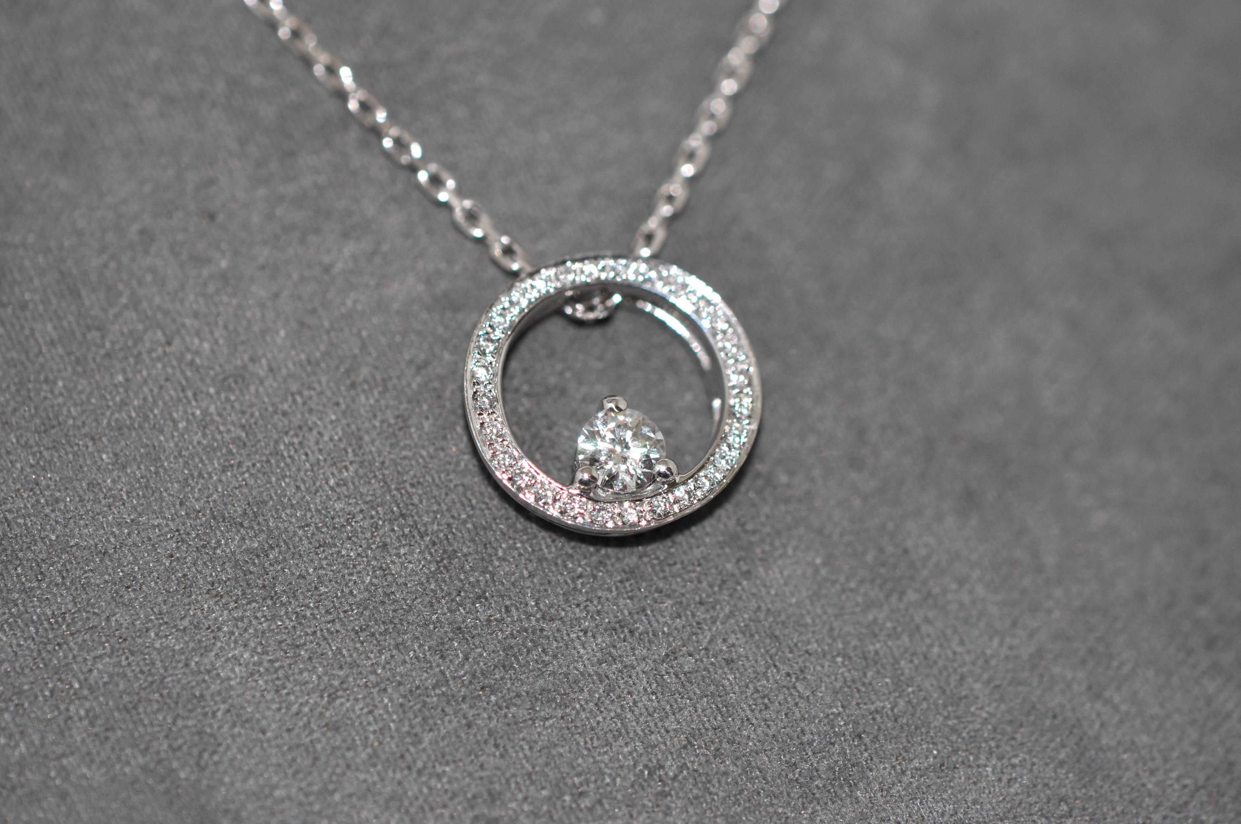 Discover this White Diamonds Crimp in a Circle White Gold Pendant Necklace.
White Gold 18 Carat Chain
White Gold 18 Carat Pendant 
White Center Diamond 0.23 Carat Color H purity SI 
29 White Diamonds Color H 0.11 Carat