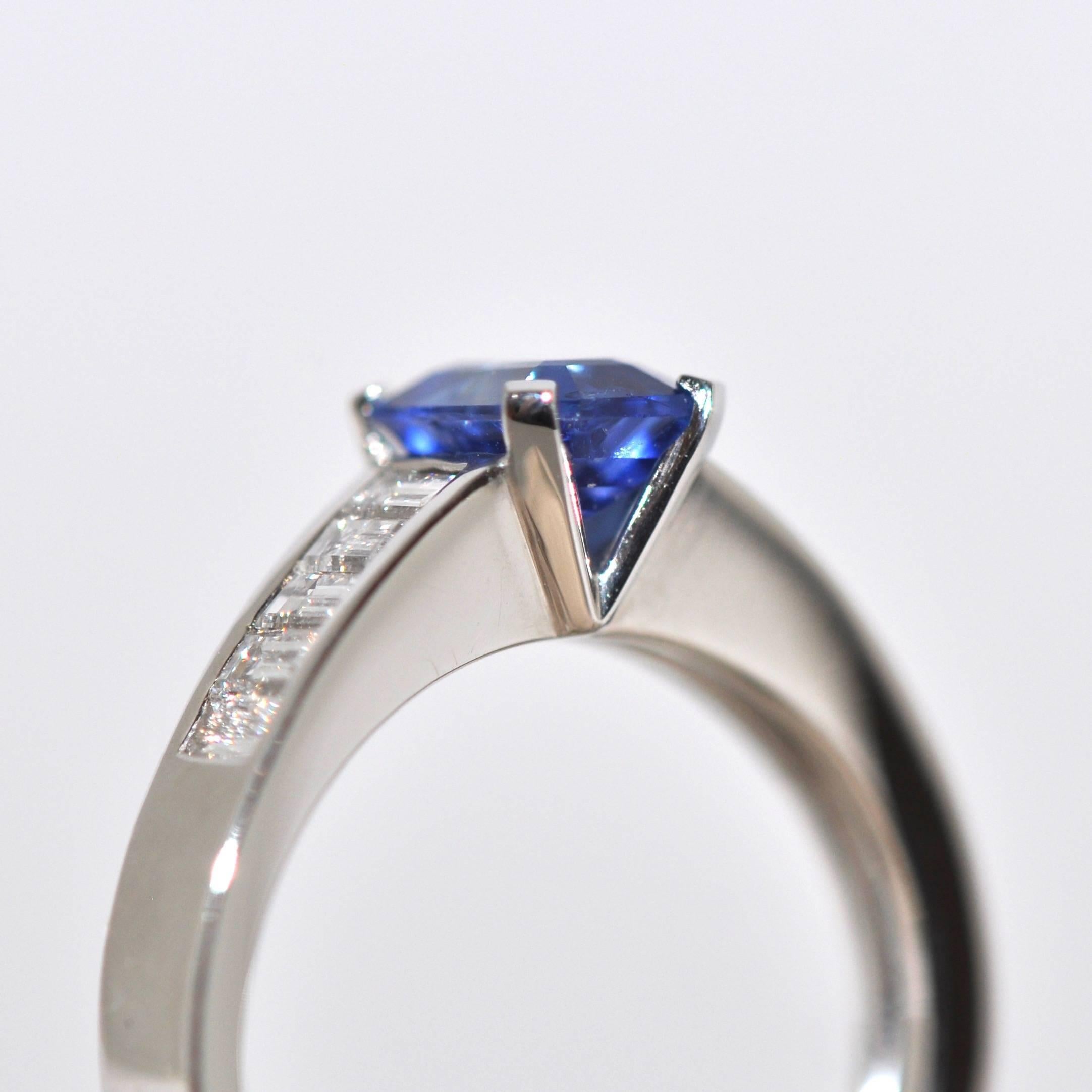  Blue Sapphire Emerald Size and White Diamonds White Gold Unique Ring.
Blue Sapphire 1.22 Carat
10 White Diamonds color F/G 0.59 Carat
White Gold 18 Carat
French Size 53 / US Size 6 1/4
