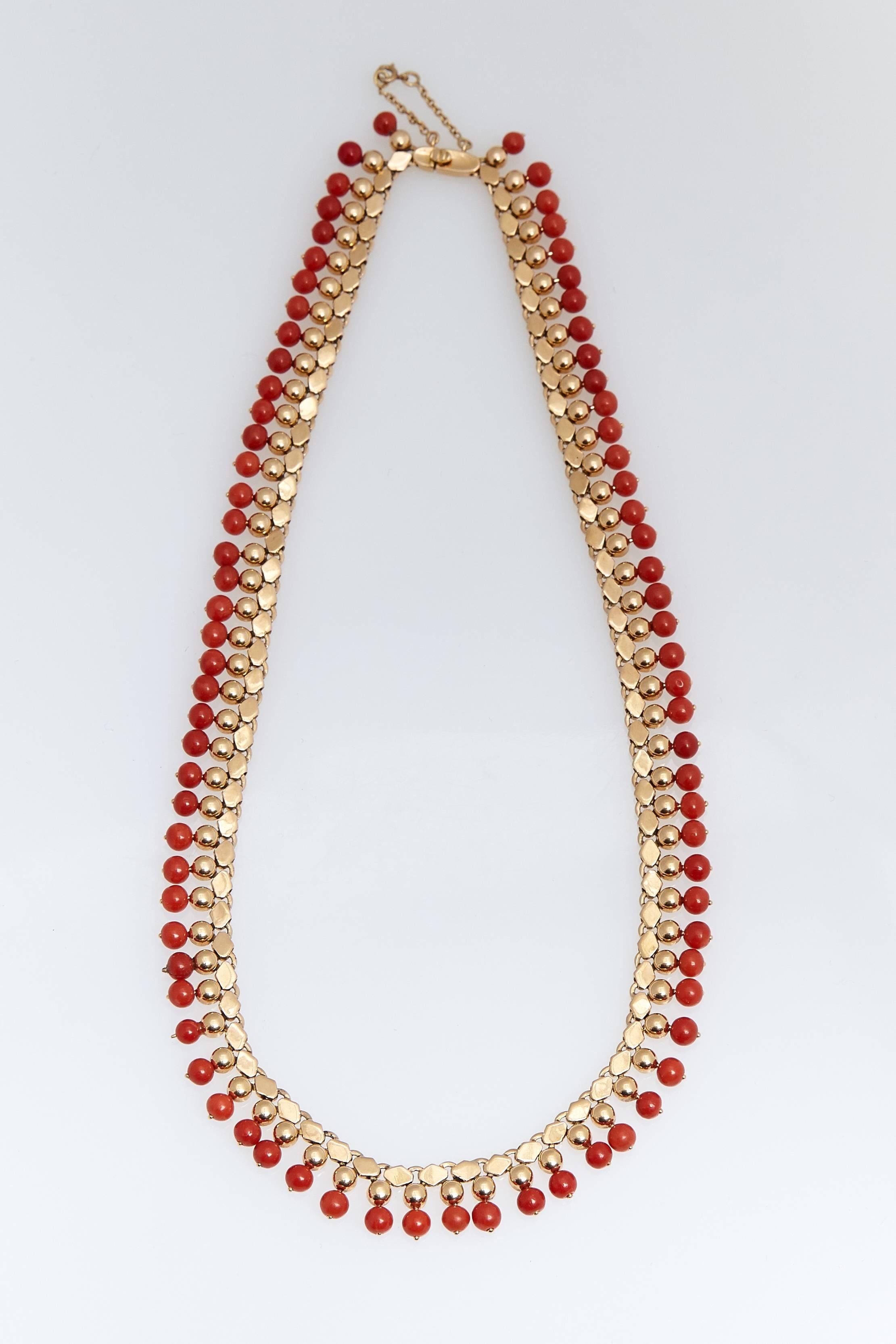 Beautiful 18 karat yellow gold and coral beads necklace. The  coral beads are attached to gold beads which are attached to gold links.  The necklace measures approximately 17 3/4 inches long.