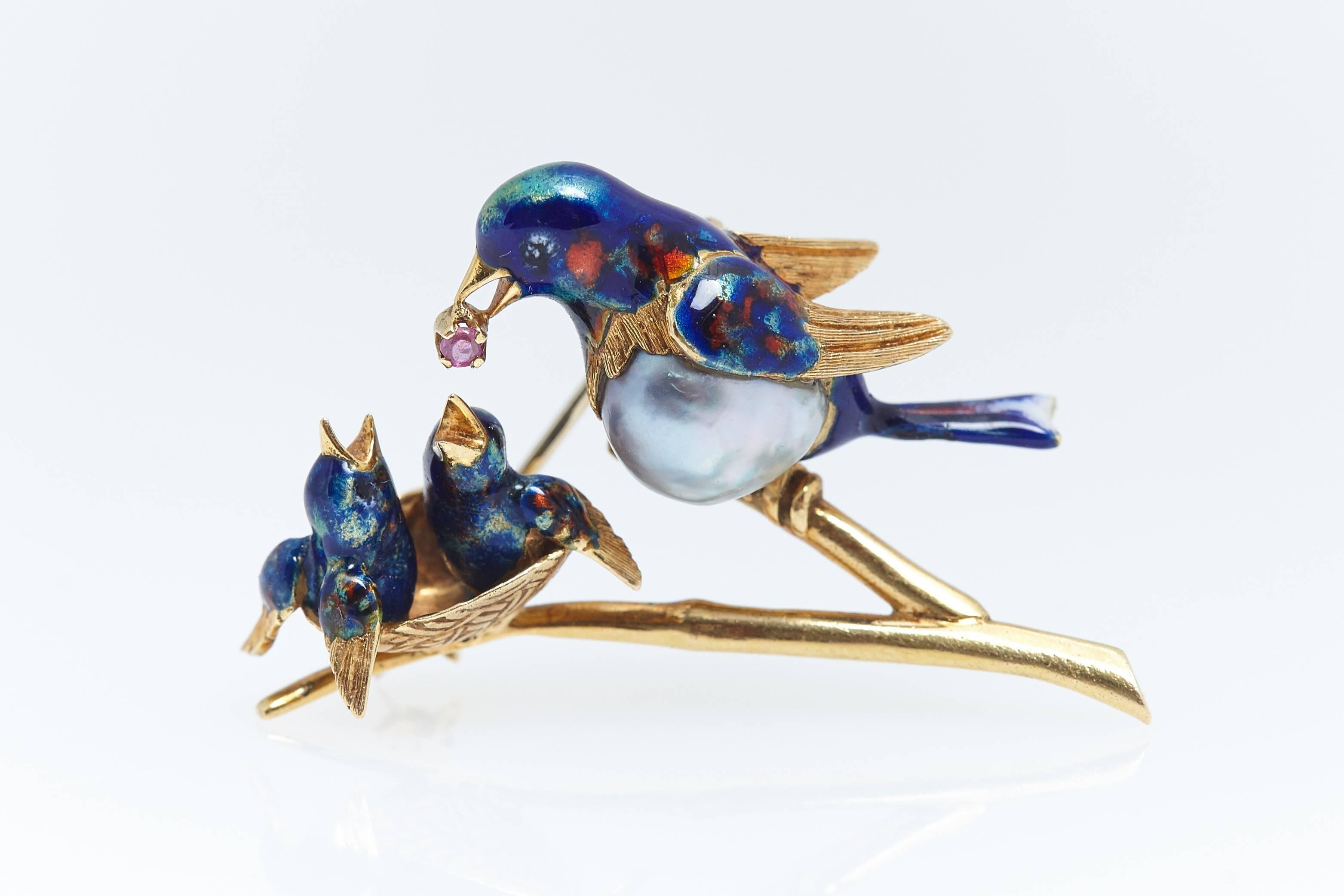 What you expect from Cartier. This beautiful enamel pin made with a pearl, enamel and 18 karat yellow gold of a mother bird feeding her chicks. The pin measures 1 5/8 inch across and approximately 1 inch in height. It is signed "Cartier,