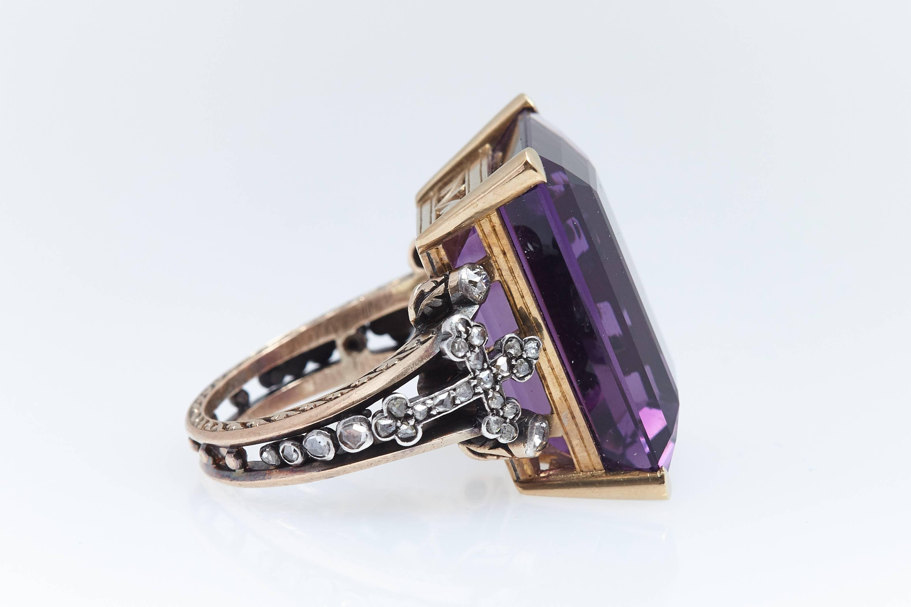     Exquisite designed bishops ring in fourteen karat yellow gold and detailing done in silver.  The amethyst weighs approximately 35 carats. It measures approximately 1 & 1/16 inch in length and 13/16 inch in width. The ring is a size 11 1/4.