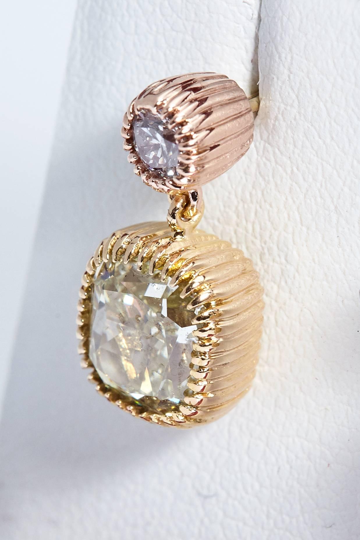 Pink and yellow eighteen karat gold and diamond dangling earrings. All the diamonds have grading reports from the Gemological Institute of America. The 2 cushion shaped diamonds have a total weight of 3.02 carats and are Fancy Light Yellow in color.
