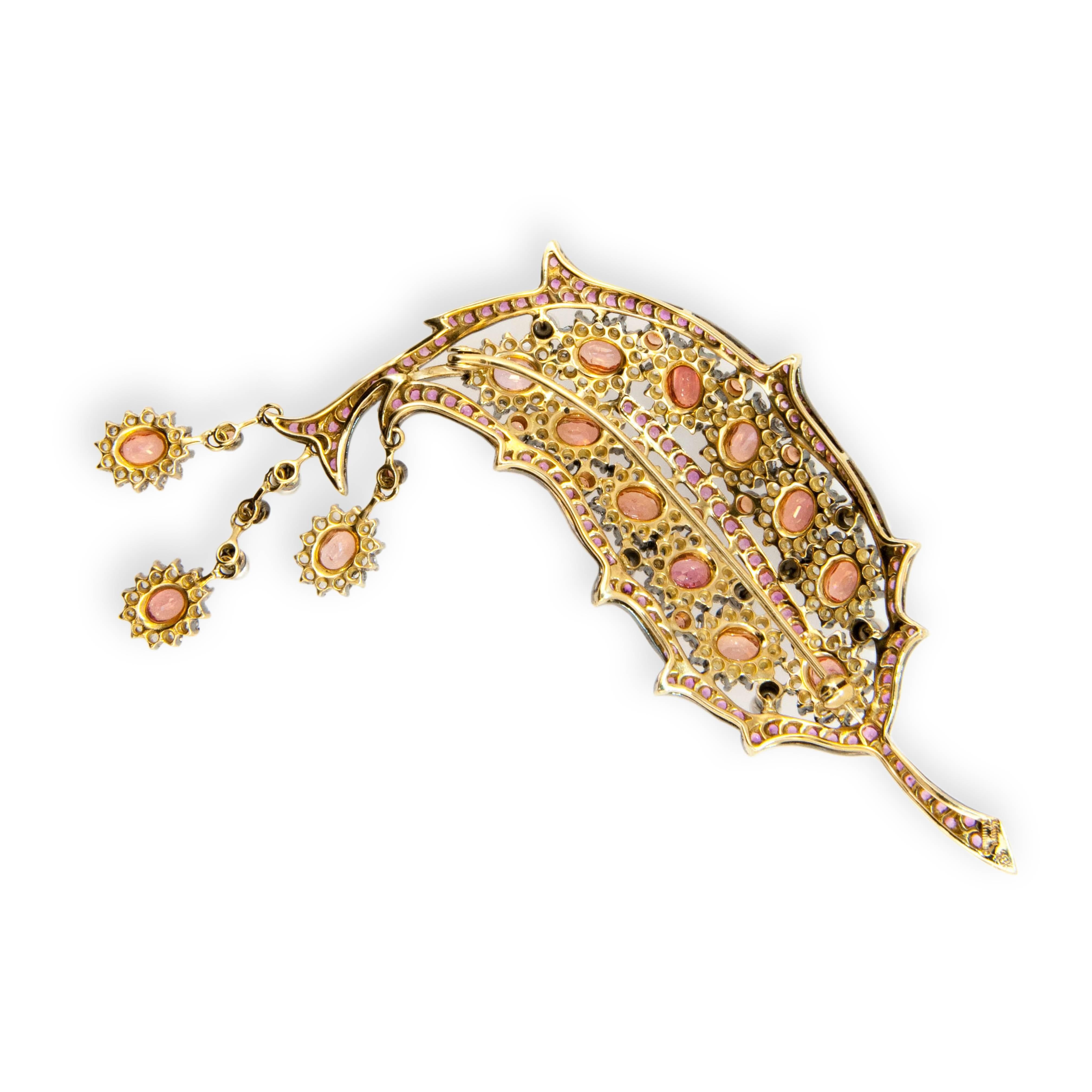 18 karat yellow gold blackened brooch Leaf design 14 oval Padparadscha color sapphires approximately 7.95 carats total weight  12 Round Padparadscha color sapphires approximately .80 carat total weight 120 Round Pink Sapphires approximately 3.95