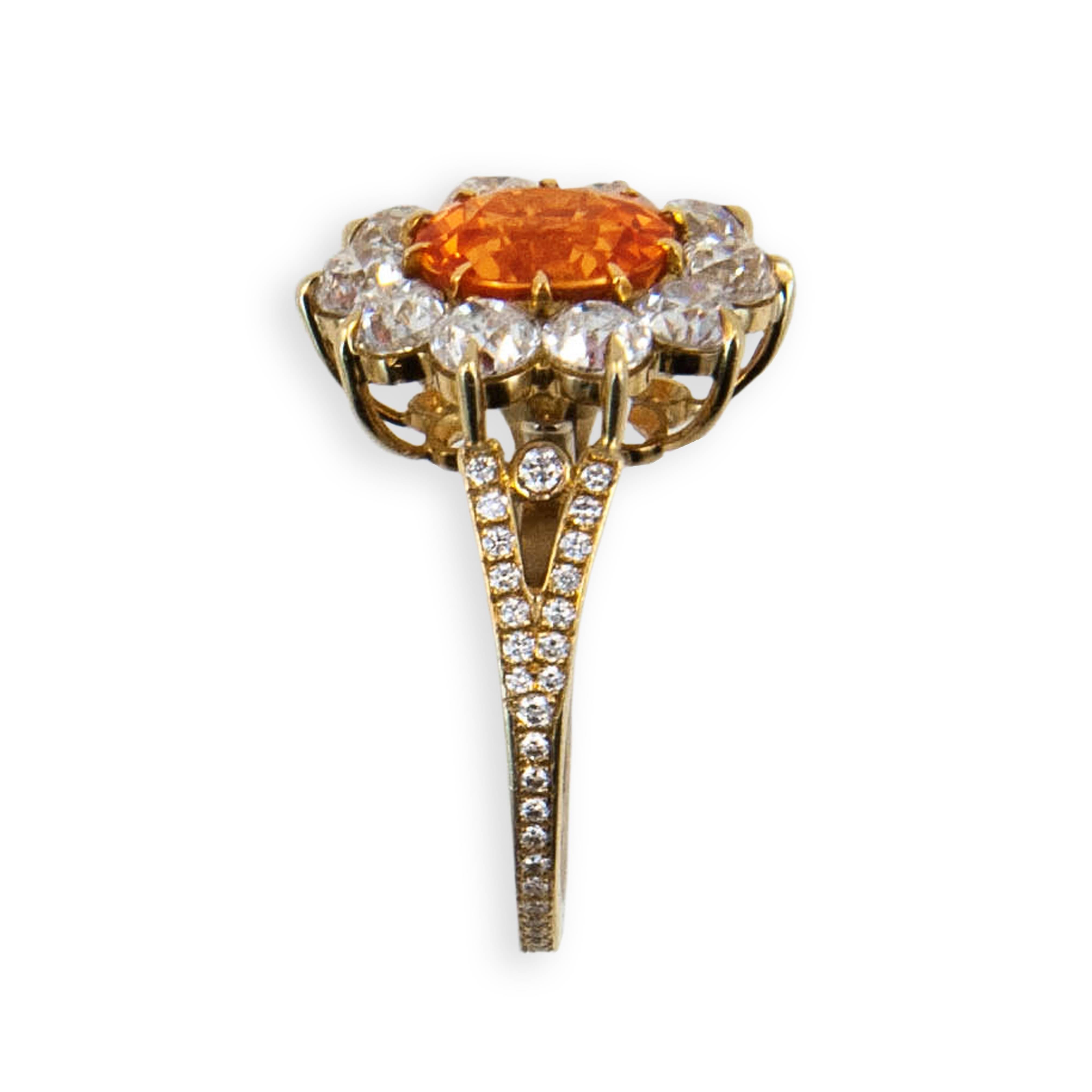 18 karat yellow gold ring set with one slightly ovalish faceted antique style cut Mandarin Garnet 4.47 carats total weight (10) 3.6 mm Mine cut Diamonds 3.04 carats total weight and (58) .9 to 1.5 mm round Diamonds .25 carat total weight Size 6 3/4