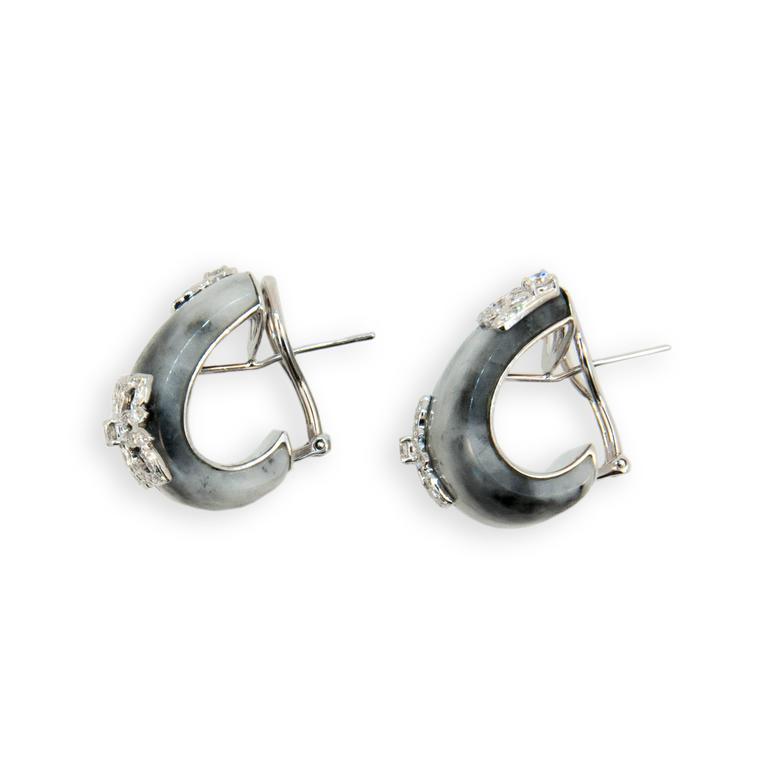 18 karat white gold earrings J shaped hoop Zebra print Jade with raised diamond design at opposite corners set with 118 diamonds (59 each earring) total 1.03 carats total weight. Posts with omegas.