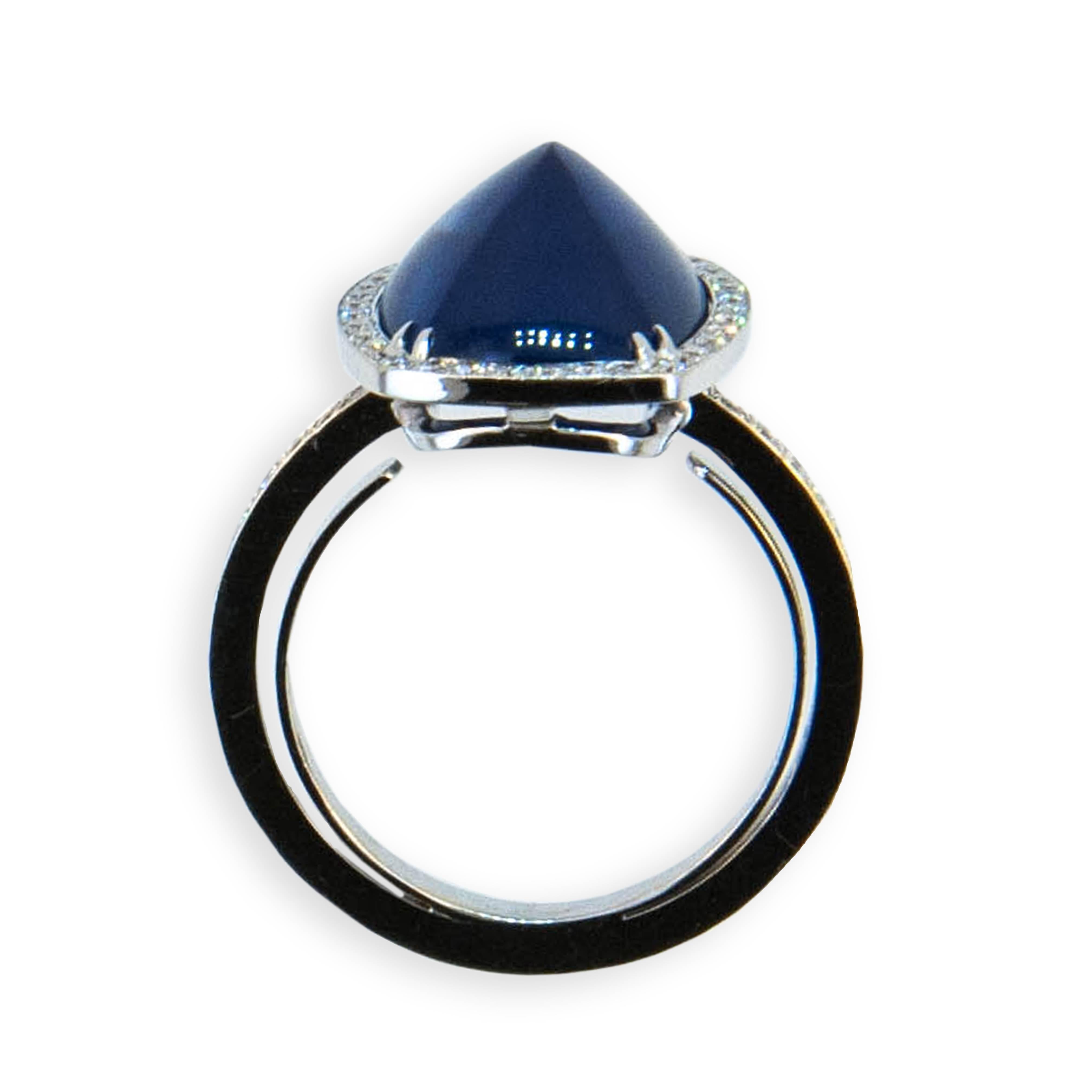 18 karat white gold ring set with (1) 9.02 carat sugarloaf cut Blue sapphire set with (70) microset diamonds .40 carats total weight. Size 6 3/4.
With Horseshoe in shank.