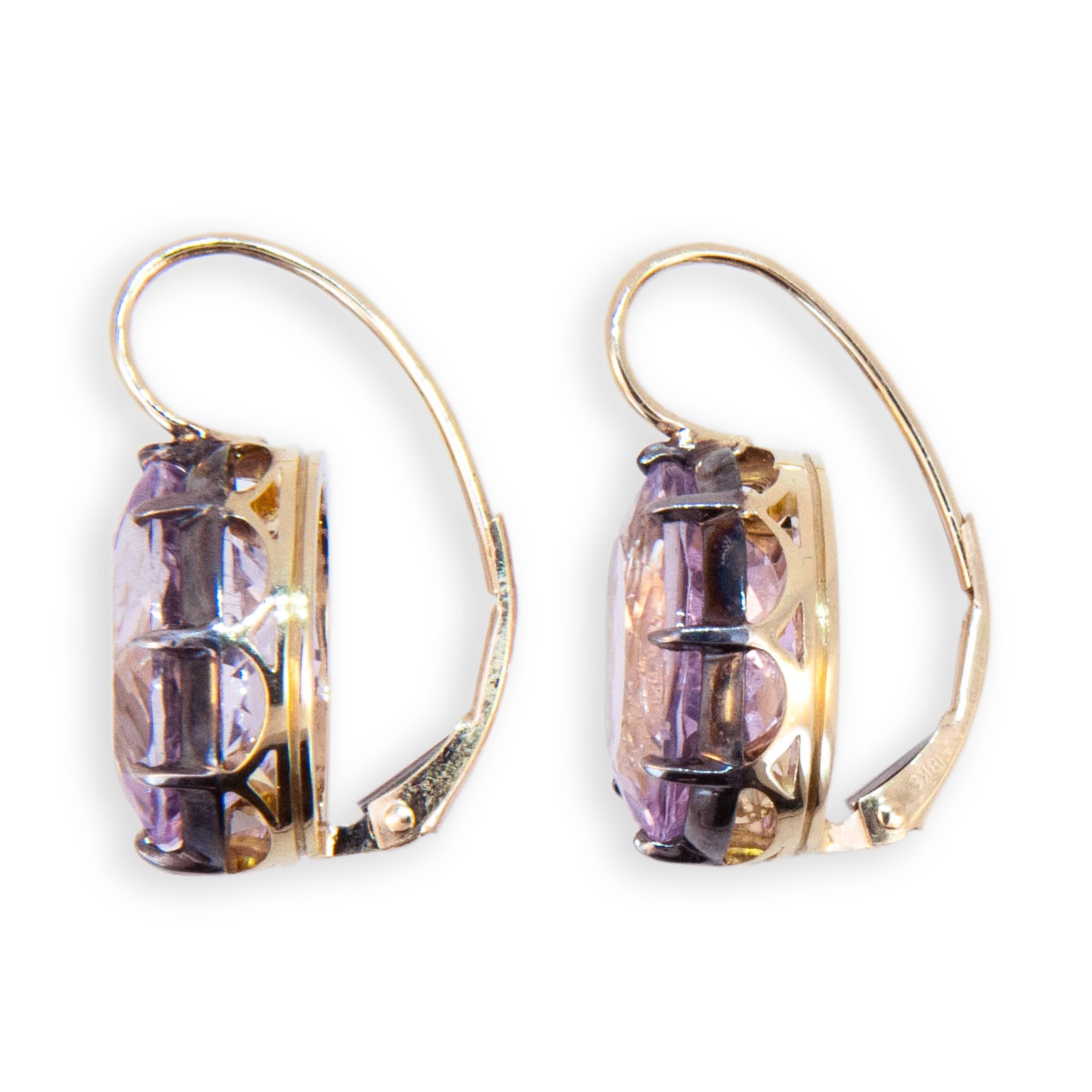 18 karat yellow gold and sterling silver on a wire earrings each set with one oval Kunzite measuring approximately 13.8 x 9.8 mm. 13.74 carats total weight. Leverbacks. 
