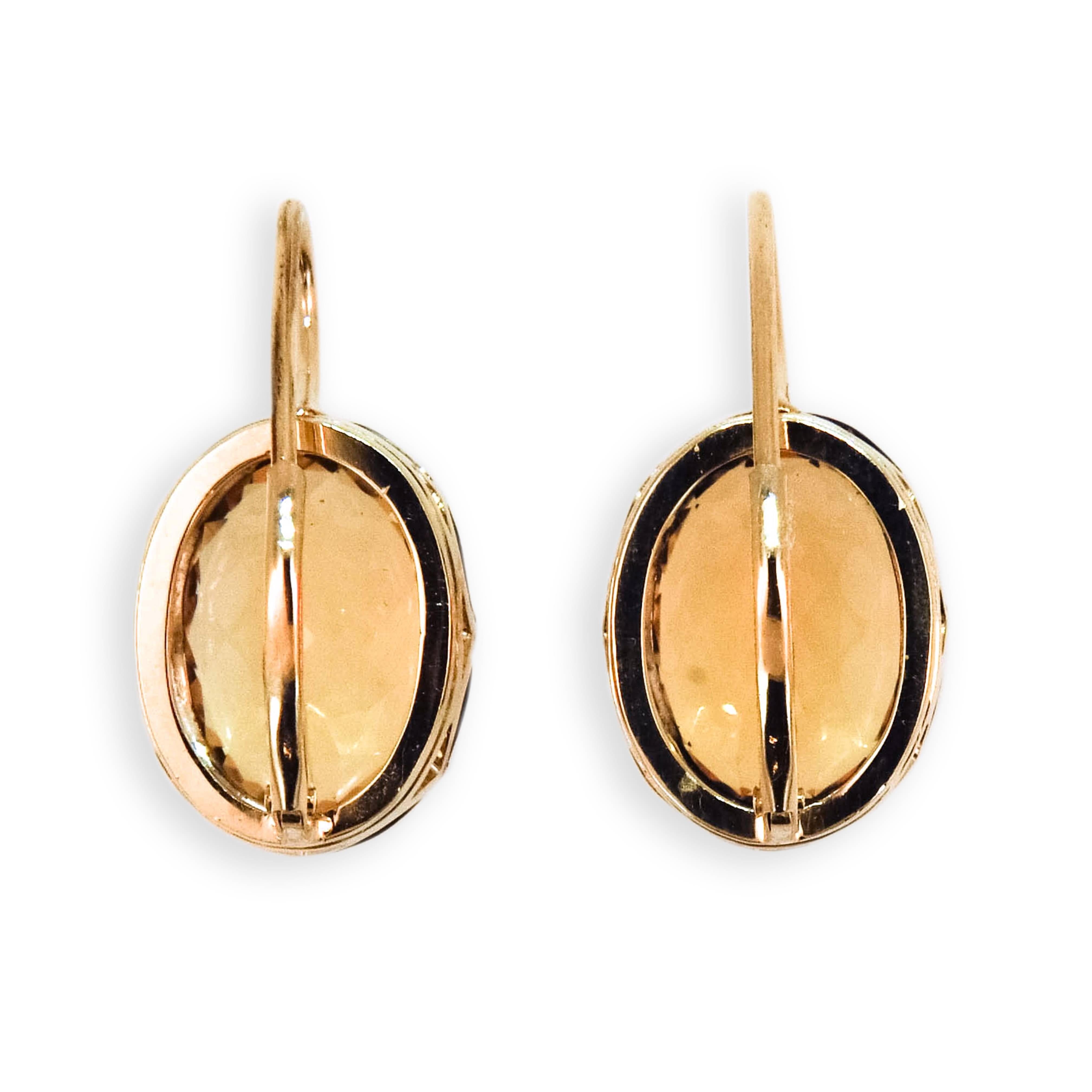 18 karat yellow gold and sterling silver on a wire earrings each set with one oval citrine measuring approximately 14 x 10 mm. 11.43 carats. total weight. Leverbacks