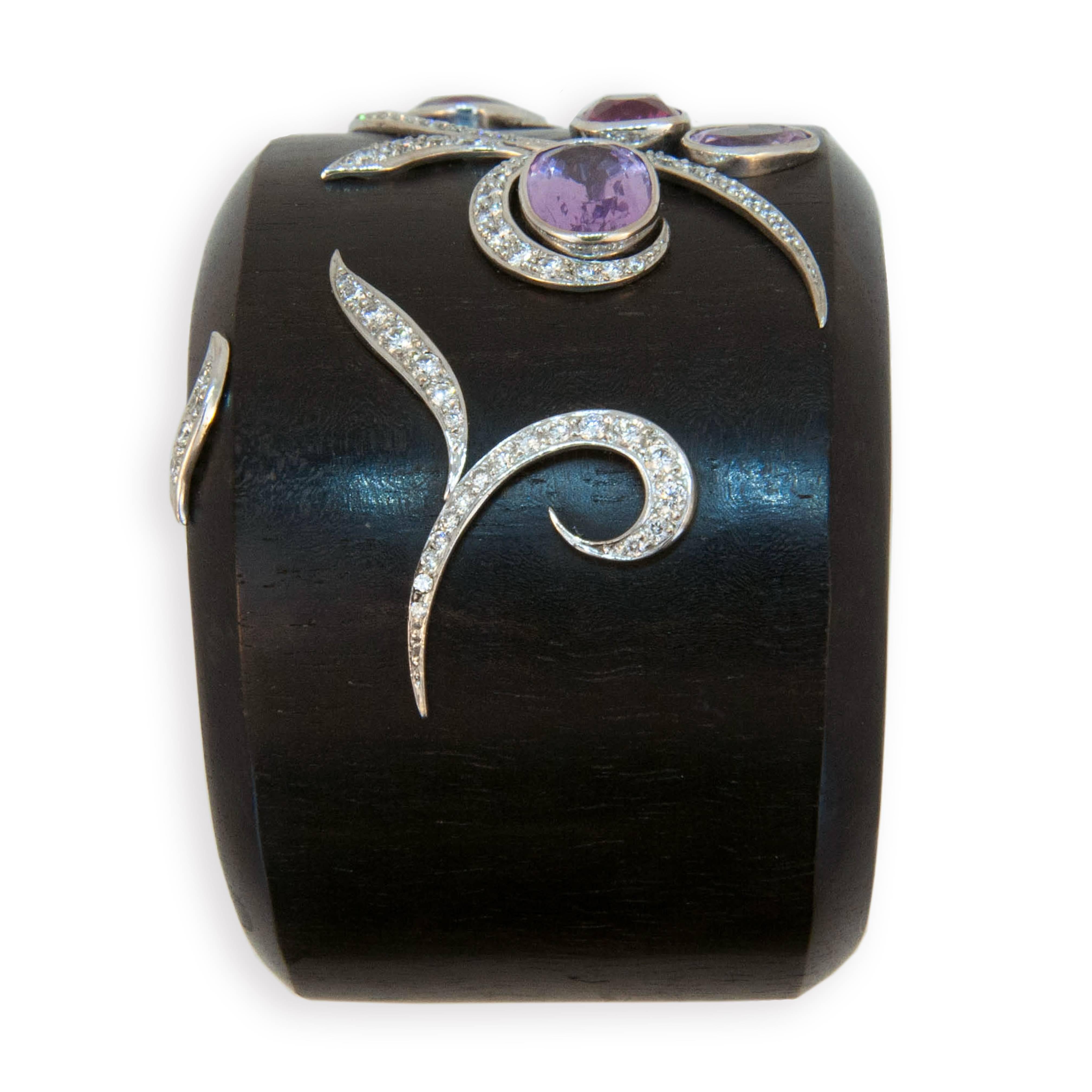 18 karat white gold and wood cuff bracelet set with five cushion/oval multi-color Spinels (light/dark pink and light purple) 11.94 carats total weight. Curved white gold strips set with 106 Diamonds 1.65 carats total weight.  
