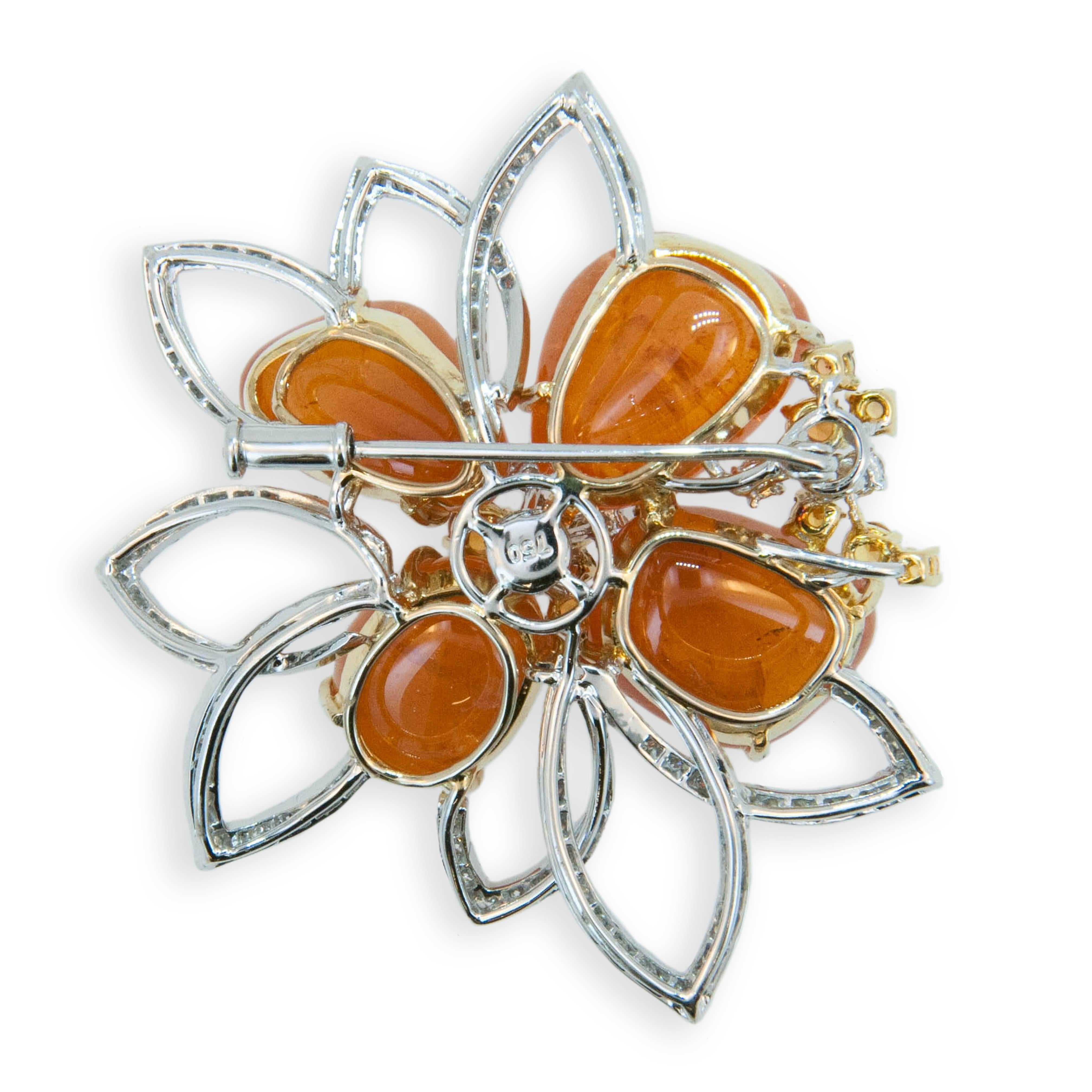 18 karat yellow and white gold brooch with Mandarin Garnet 63.09 carats total weight. Ten Yellow and Orange Sapphires 0.82 carats total weight. 112 Round diamonds 1.47 carats total weight.