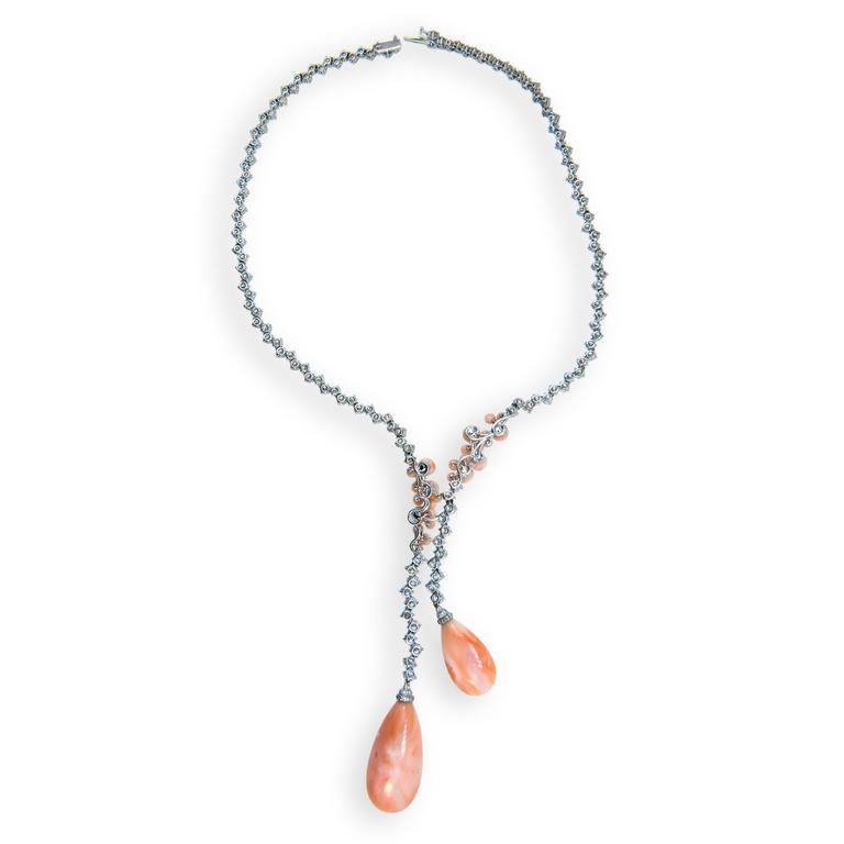 18 karat white gold necklace coral drops one weighing 8.37grams and one weighing  3.54grams , 26 coral beads 2.50grams and 142 round diamonds 15.44 carats and 57 diamonds .24 carats. 