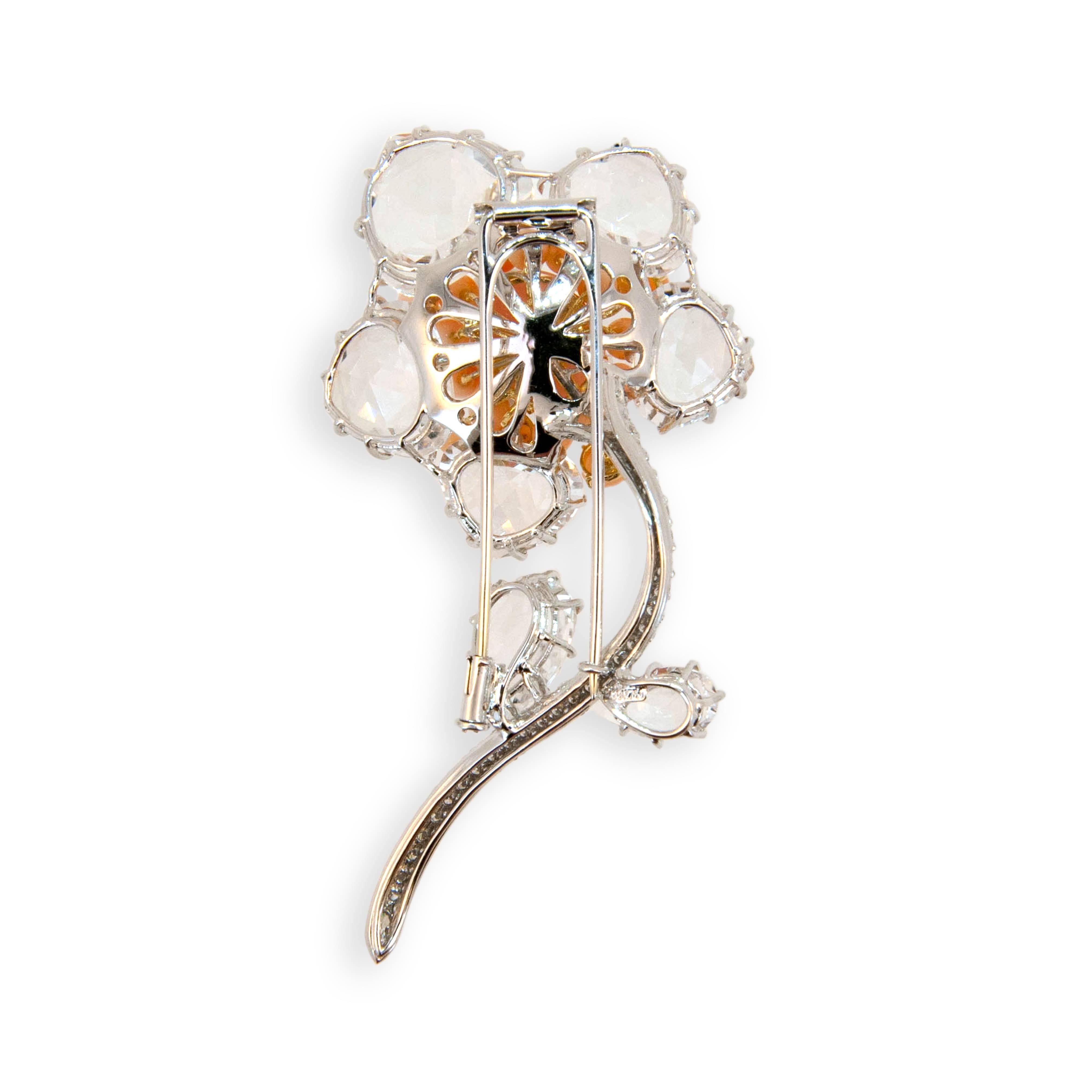 18 karat white gold brooch flower design set with one Pink Opal cab 7.62 carats total weight. Seventeen Coral beads 1.16 grams, seven crystals, one Marquise Diamond .10 carats and ninety-five round diamonds 1.14 carats total weight.
