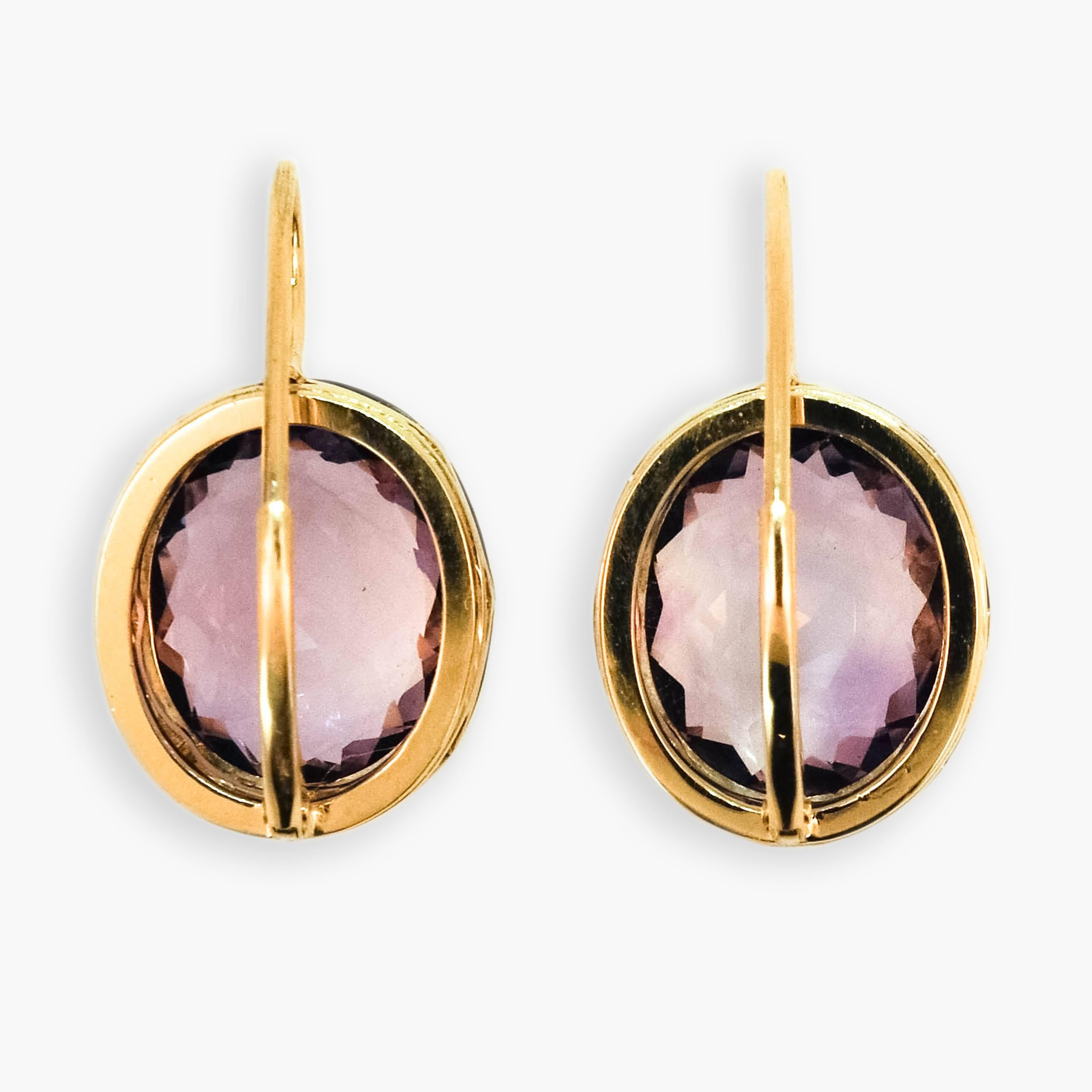 18 karat yellow gold and sterling silver on a wire earrings each set with one oval light lavender amethyst measuring approximately 14 x 12mm. 13.33 carats total weight. Leverbacks.