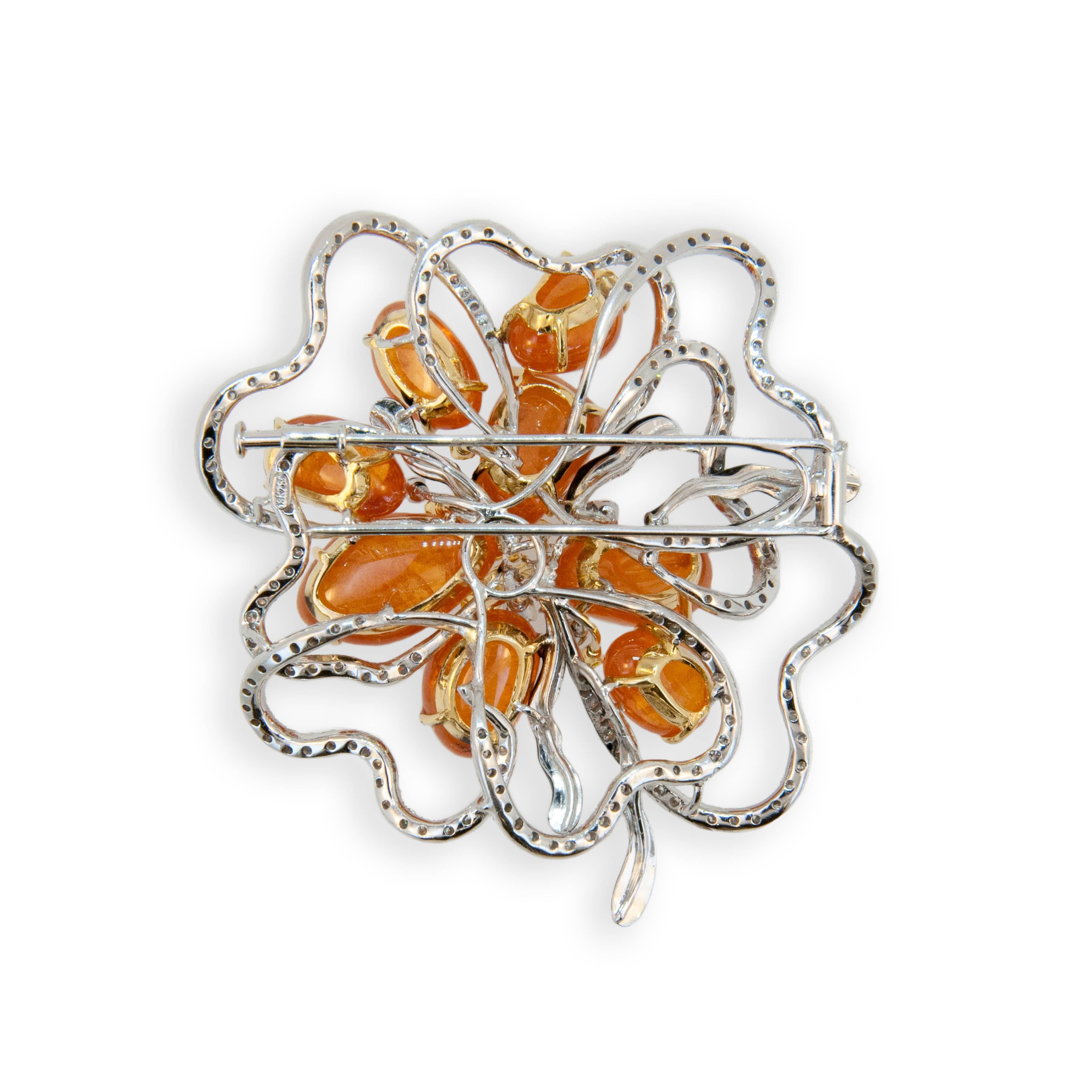 18 karat white and yellow gold brooch set with eight Mandarin Garnets 84.25 carats total weight. 214 Round Diamonds 3.07carat total weight. 8 yellow diamonds .40 carats total weight and five onyx and enamel freeform pieces.