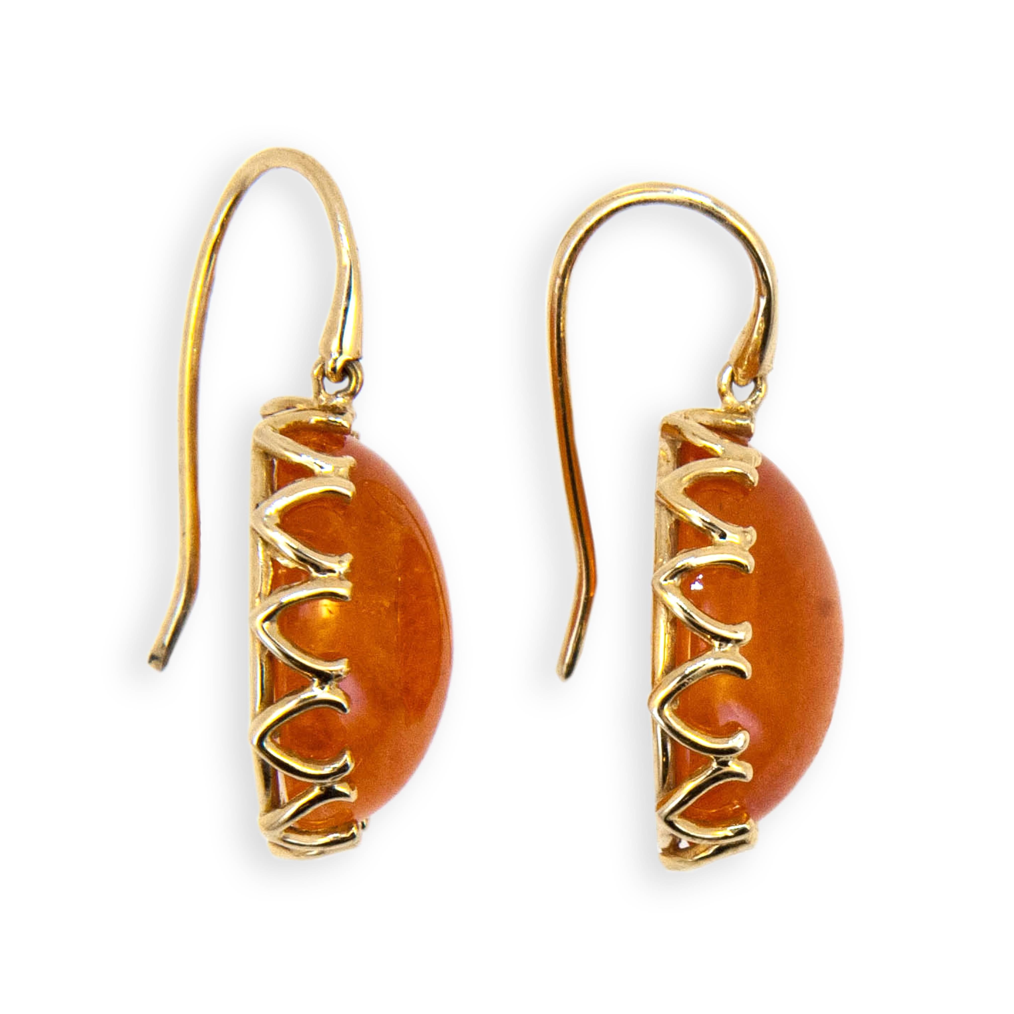 14 karat yellow gold earrings V scalloped bezel, each set with one oval cabochon Mandarin Garnet 25.44 carats total weight. Wires.

