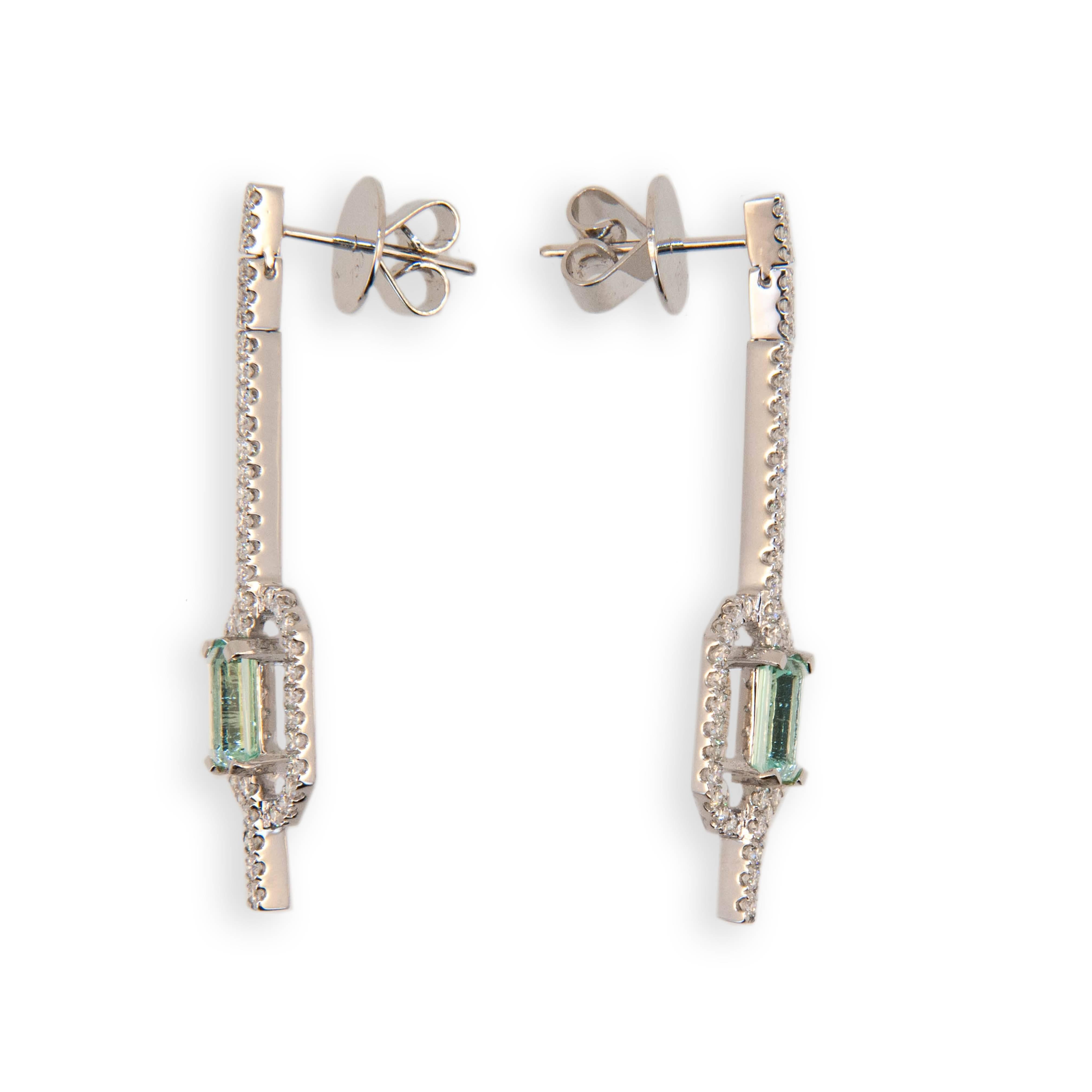 18 karat white gold earrings each set with one emerald cut Mint Green Tourmaline two are 1.58 carats total weight. Micro-set in a straight line from post and in an octagonal frame around Tourmaline are 47 Diamonds 94 total .93 carat total weight.