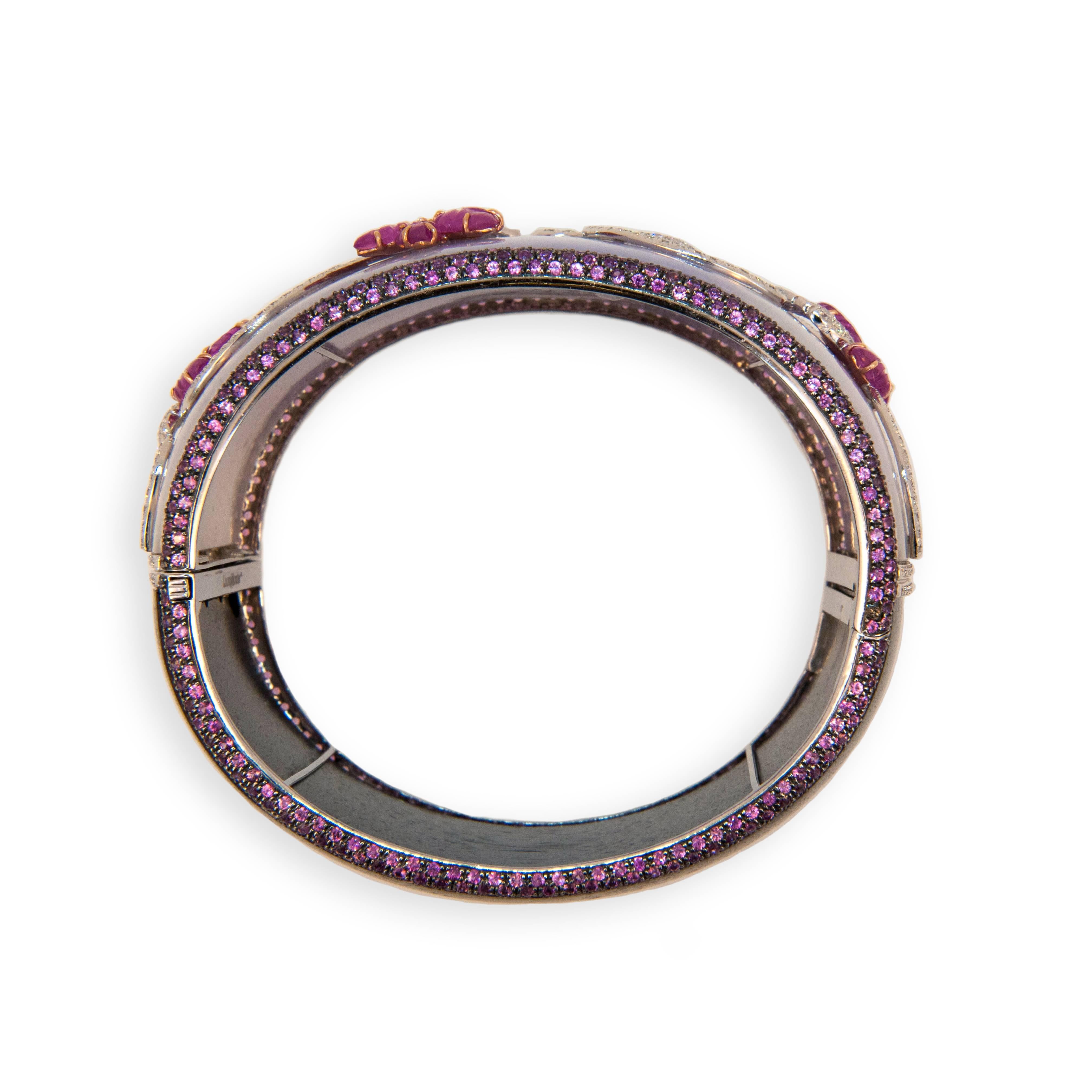 18 karat rose and white gold and blackened white gold hinged bangle bracelet, half Lavender Jade, half Grenadill wood 1.5 inches wide with pave pink sapphire edge 598 pink sapphires 8.77 carats total weight. Lavender Jade is set with 10 carved Ruby