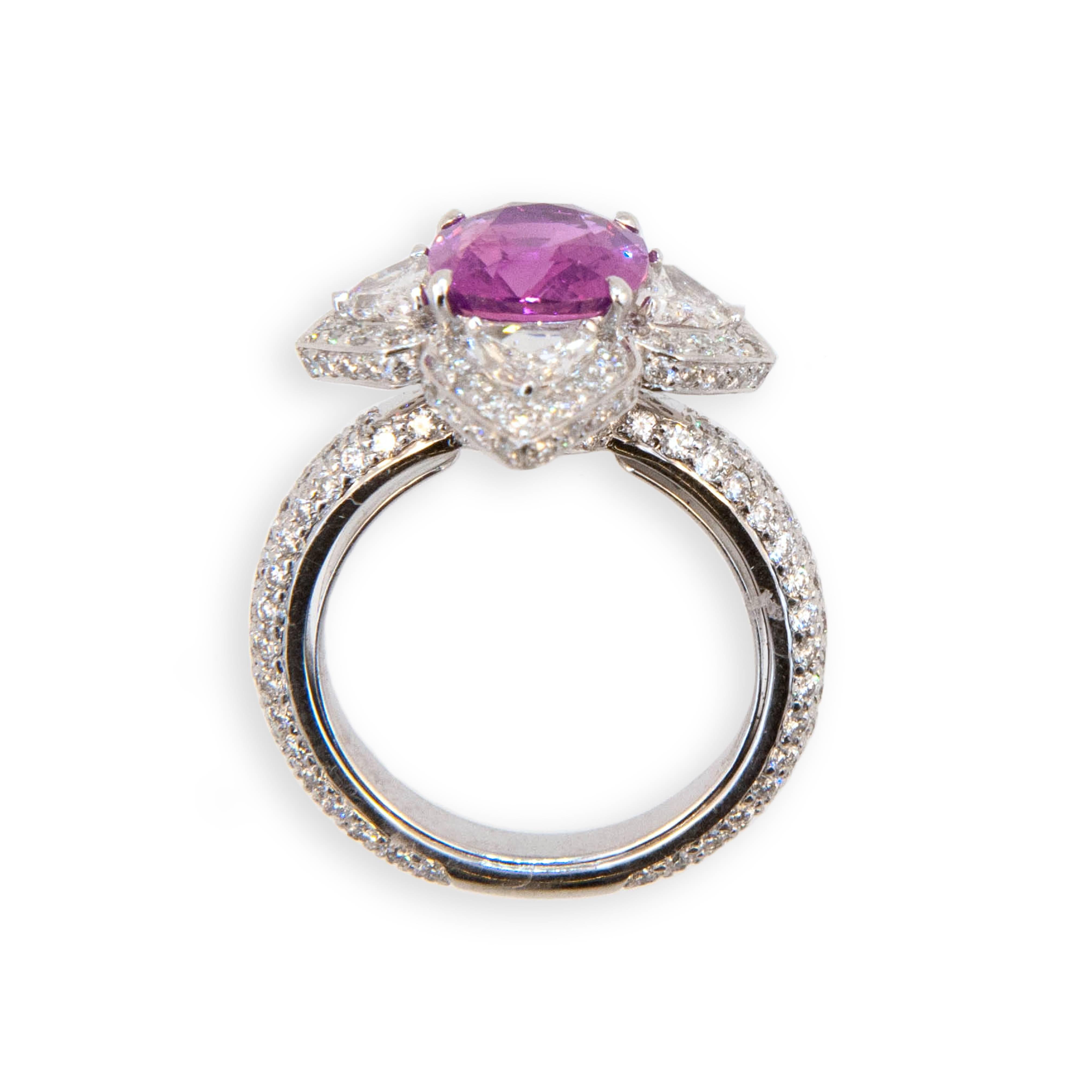 18 karat white gold ring set with one faceted cushion cut Pink Sapphire 3.35 carats.  Four fancy shield shaped Diamonds .89 carat total weight and 194 round Diamonds 1.52 carats total weight. Size 6.75 with a horseshoe.