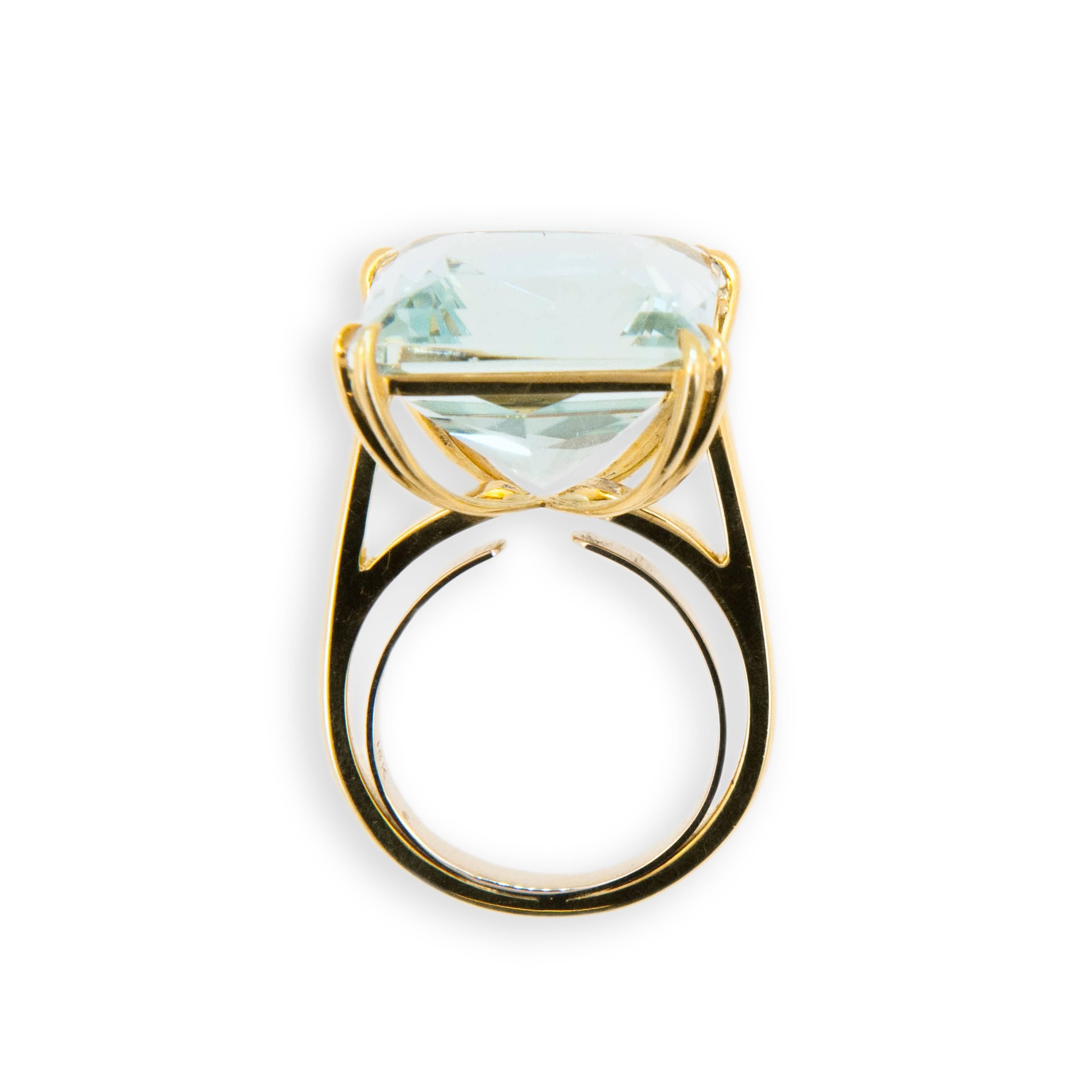 18 karat yellow gold ring set with square Aquamarine 15.21 carats. Double prong on each corner.Size 6 with a horseshoe.