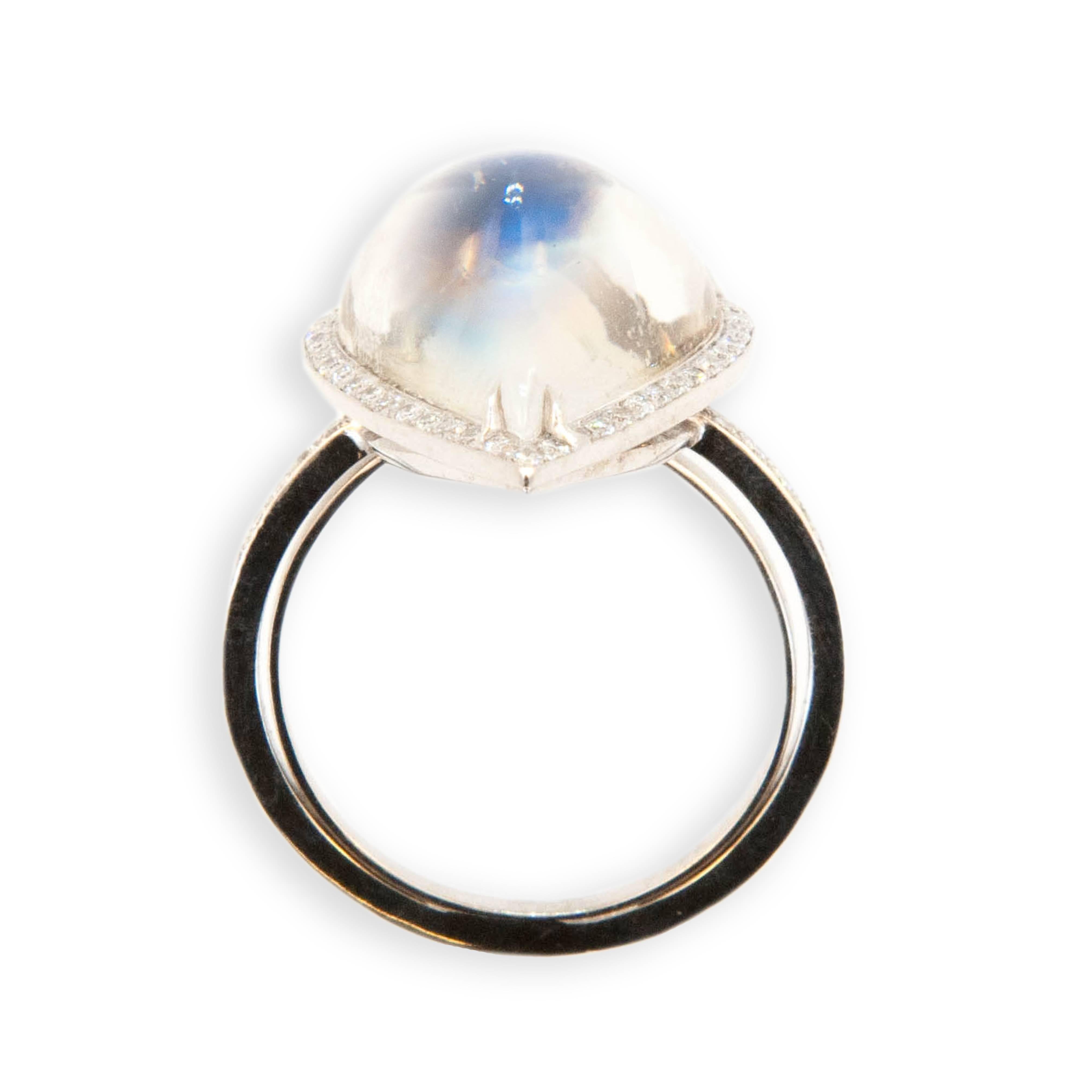 18 karat white gold ring set with one pear shape cabochon Moonstone 8.08 carats surrounded by 43 diamonds, shank is set with 36 diamonds. (79) total .33 carat total weight. Ring is a size 6.25 with a horseshoe.
