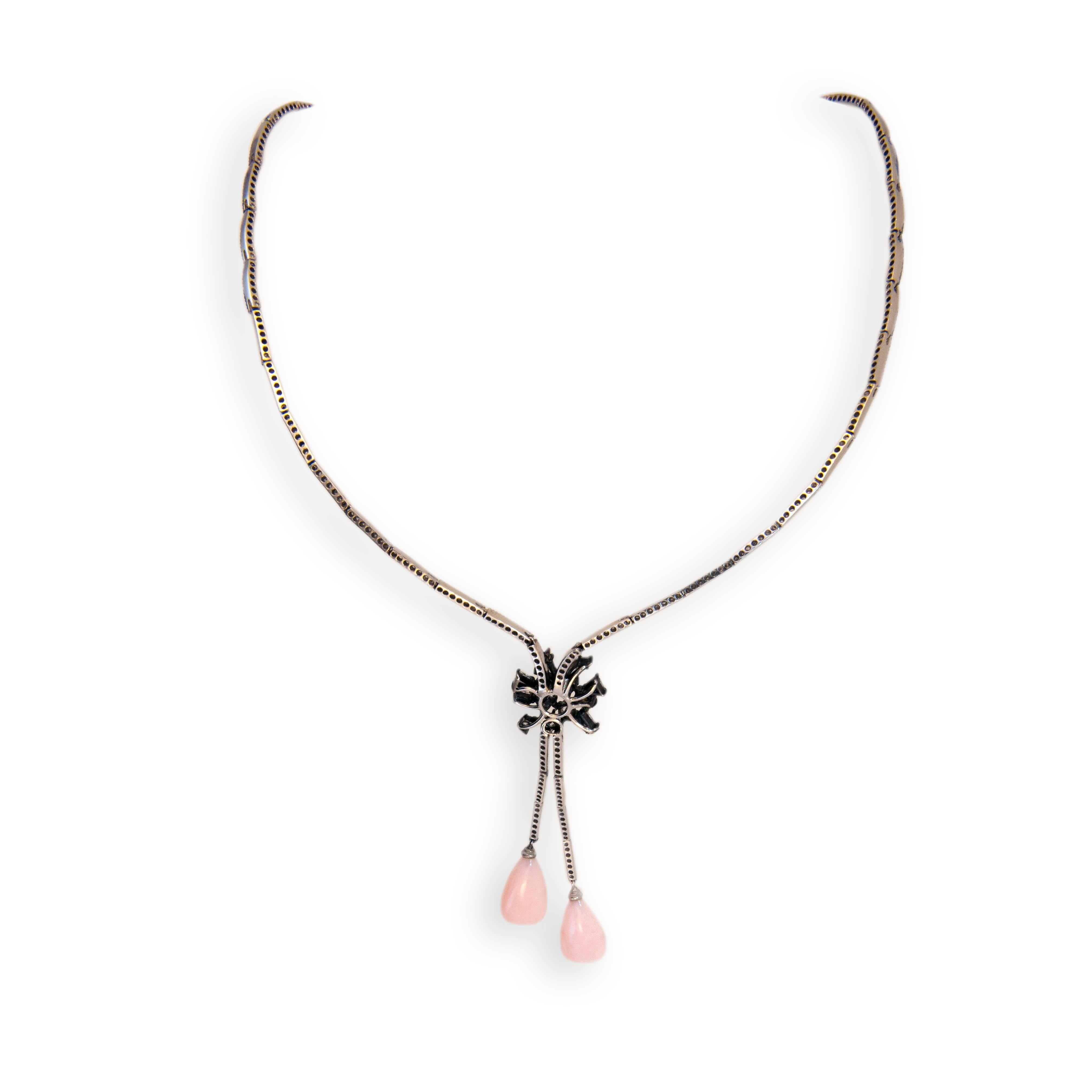 18 karat blackened white gold necklace with (2) Pink Opal drops 10.66 carats total weight, (13) fancy shaped Rose cut Diamonds 1.44 carats total weight and 331 round Diamonds 2.64 carats total weight. 16 inches length.
