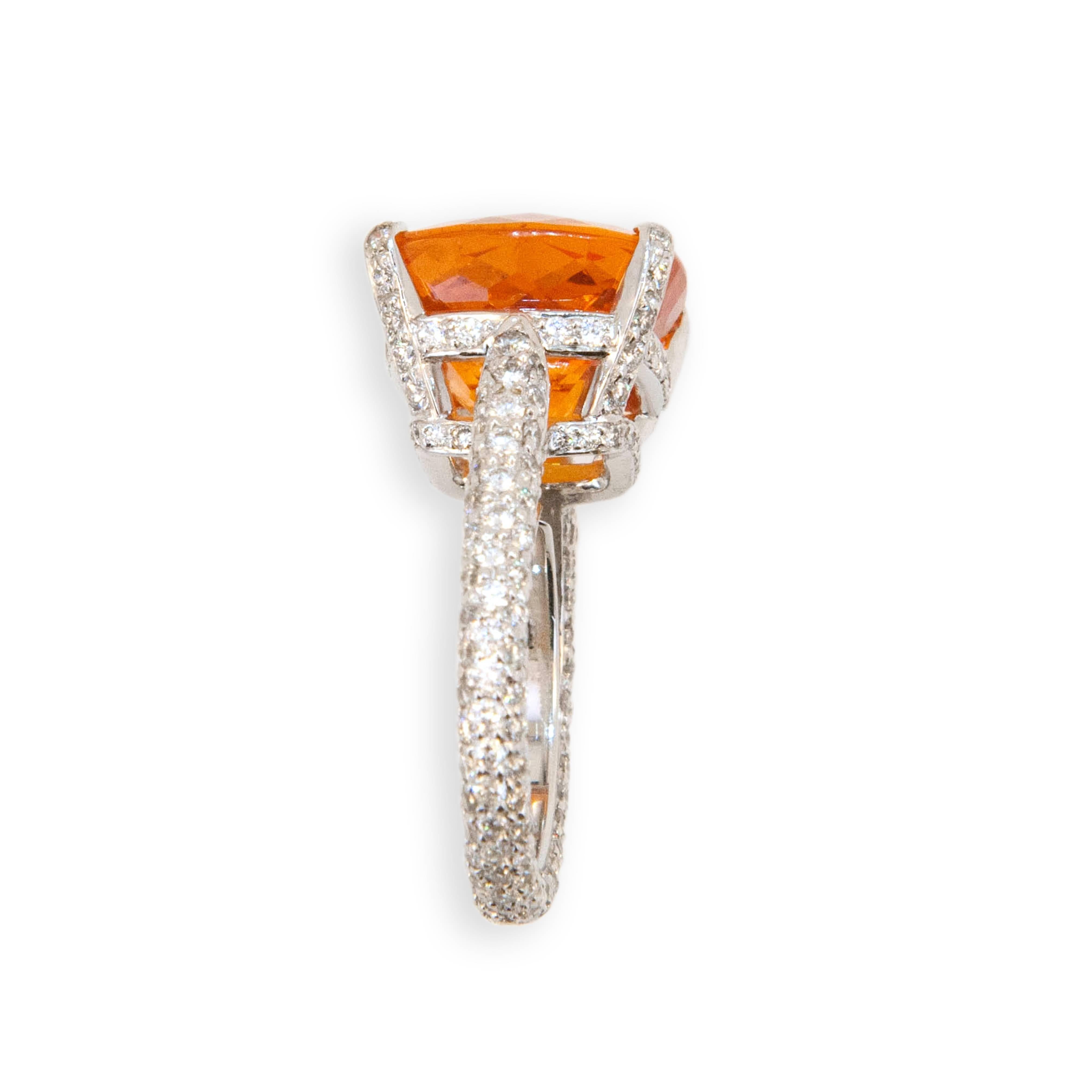 18 karat white gold ring set with one faceted cushion cut Mandarin Garnet 15.10 carats shank, under bezel and prongs are set with 234 round Diamonds 1.94 carats total weight. Ring is a size 6.25 with a horseshoe.