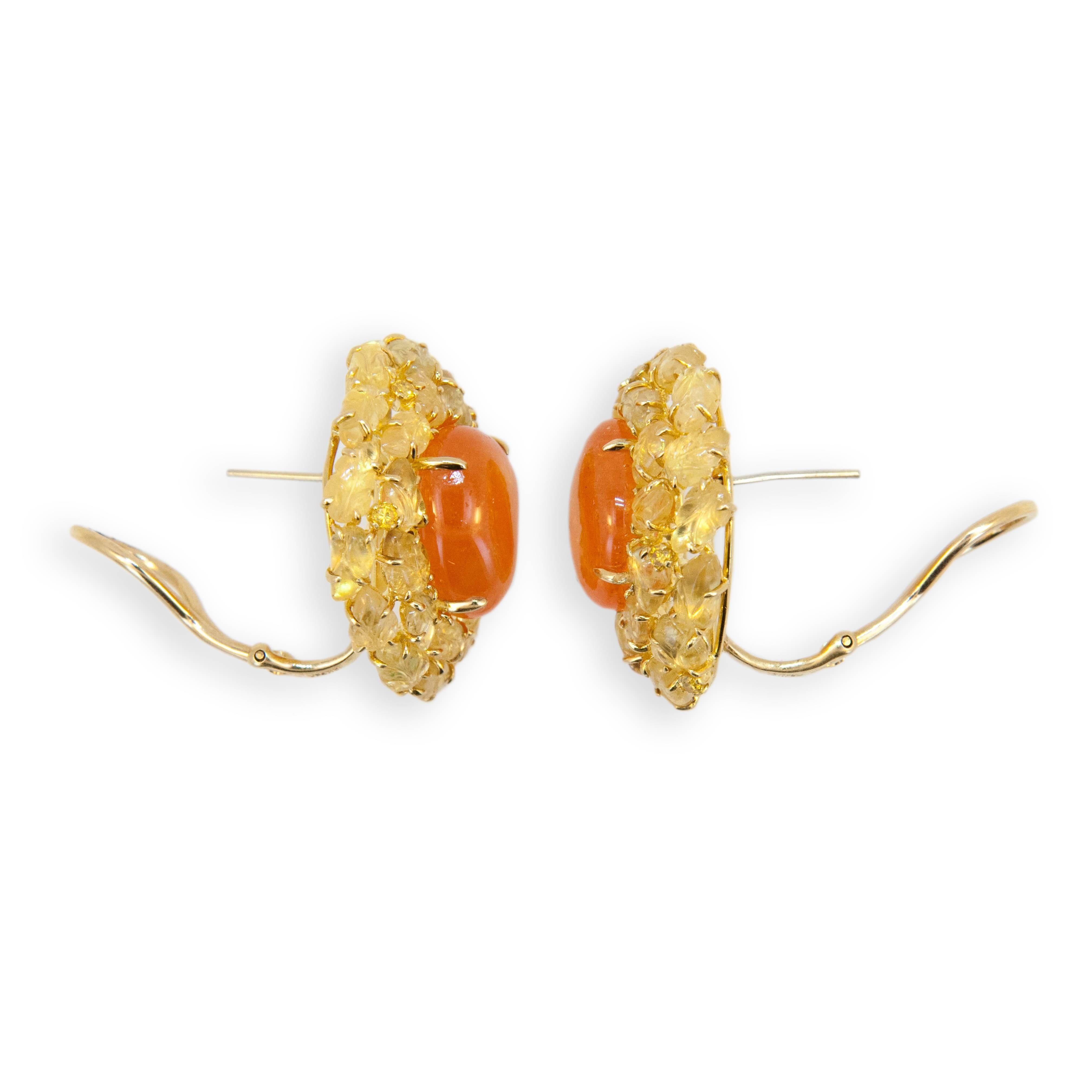 18 karat yellow gold earring (2) Mandarin Garnet 29.30 carats total weight. (47) carved yellow sapphire leaves 19.09 carats total weight and (9) yellow diamonds .30 carats total weight. Posts fold down so can be worn as clips or pierced.